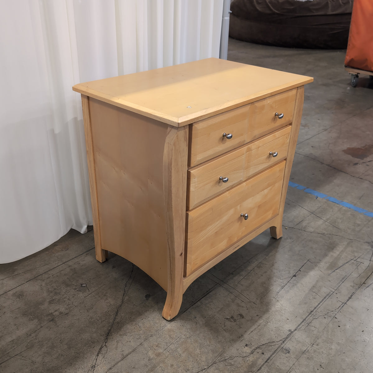 Light Wood Three-Drawer Nightstand with Curved Sides