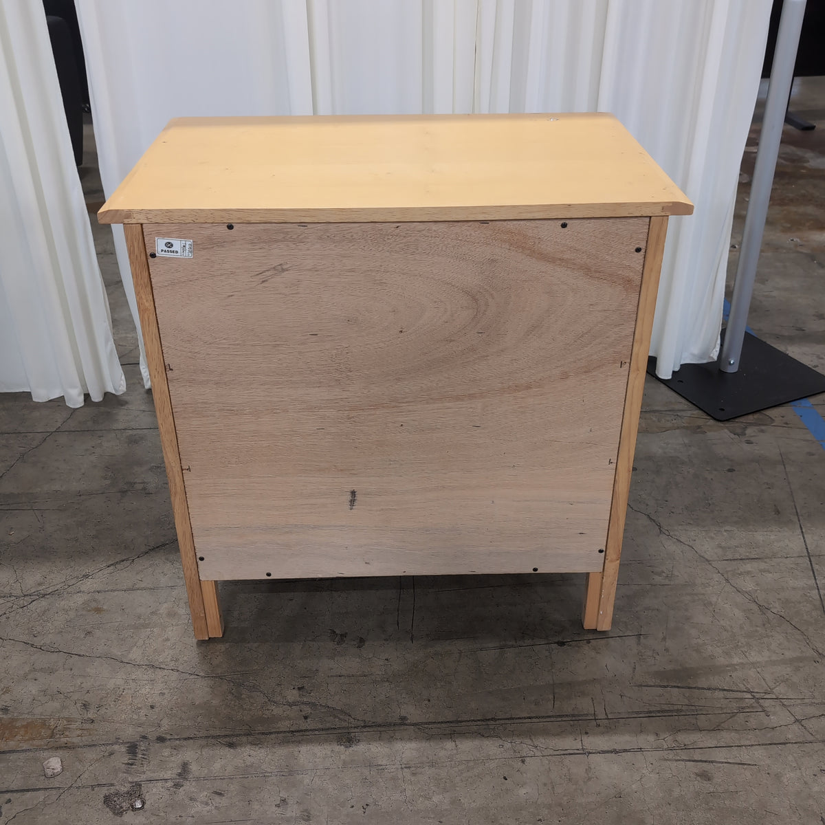 Light Wood Three-Drawer Nightstand with Curved Sides