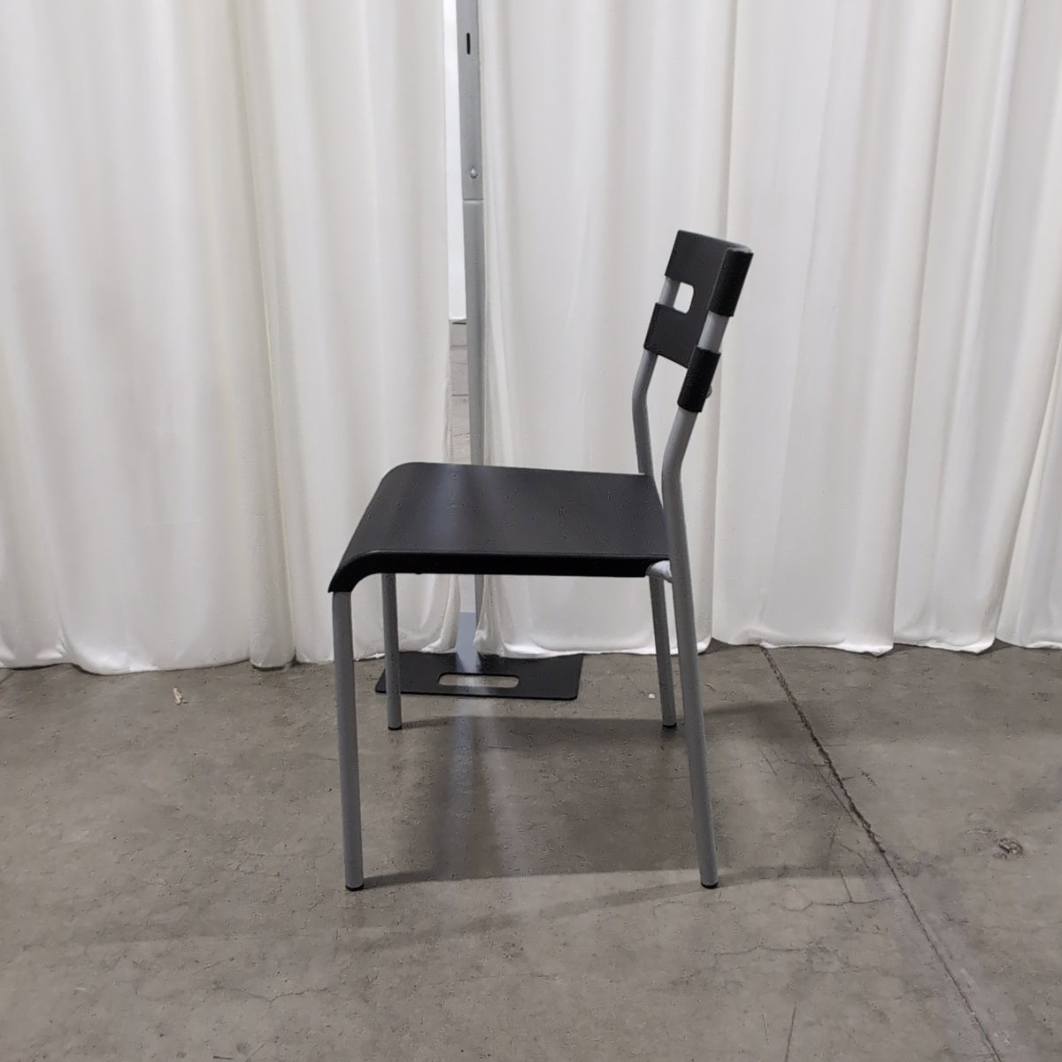 Black Plastic Stackable Chair with Striped Cushion