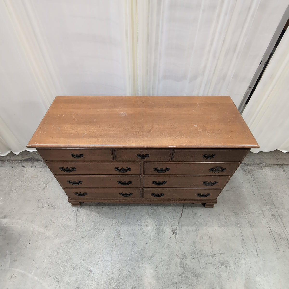Traditional Honey Tone Nine-Drawer Dresser with Ornate Hardware