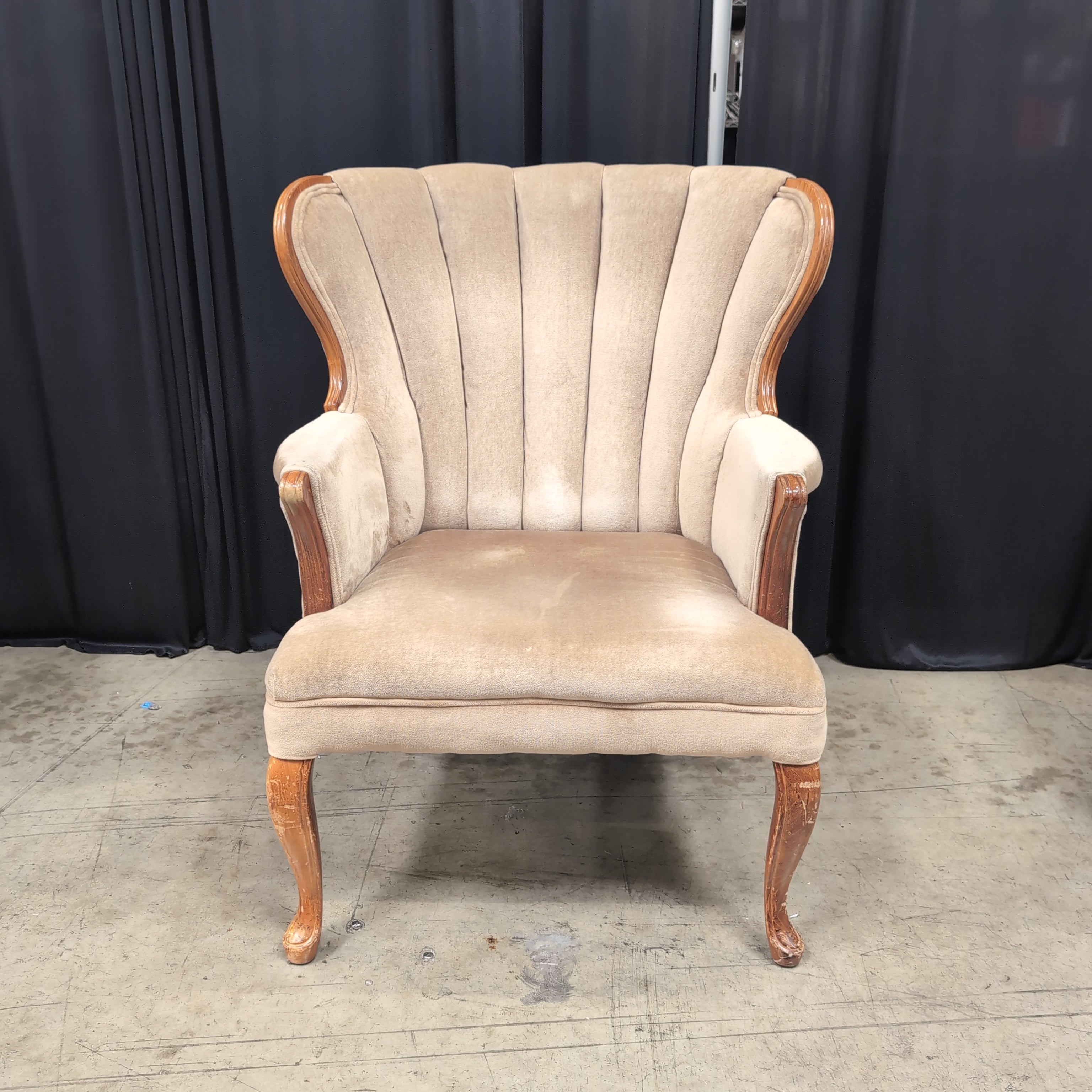 Tan Upholstered Shell Back Armchair with Carved Wood
