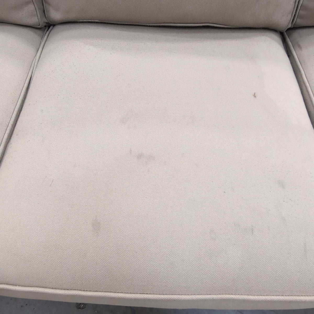 Tan Fabric Three-Cushion Couch with Rolled Arms
