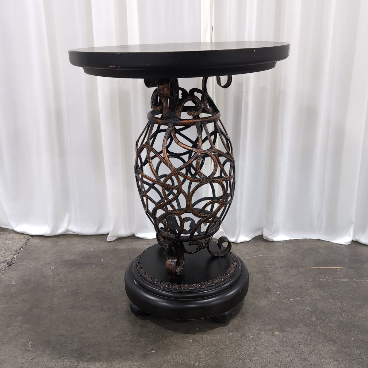 Round Dark Wood End Table with Ornate Metal Base