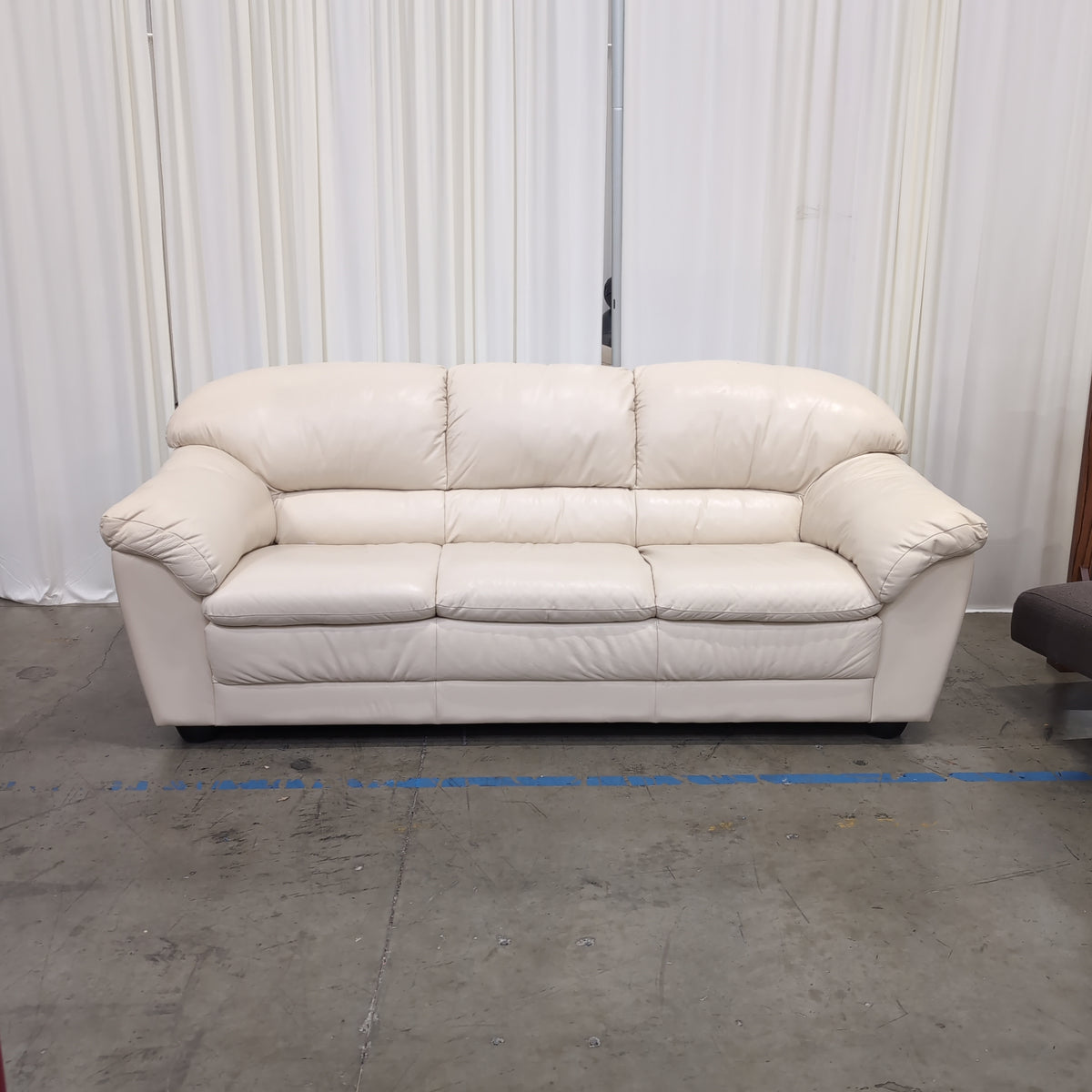 Cream-Colored Three-Seat Padded Couch