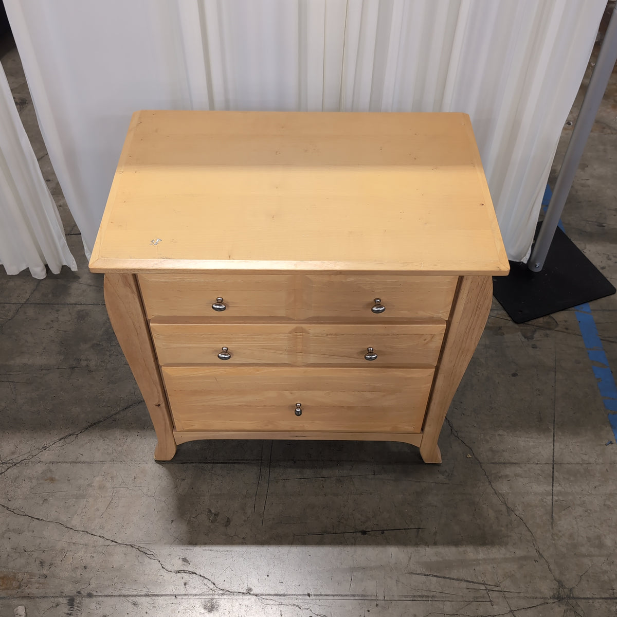 Light Wood Three-Drawer Nightstand with Curved Sides