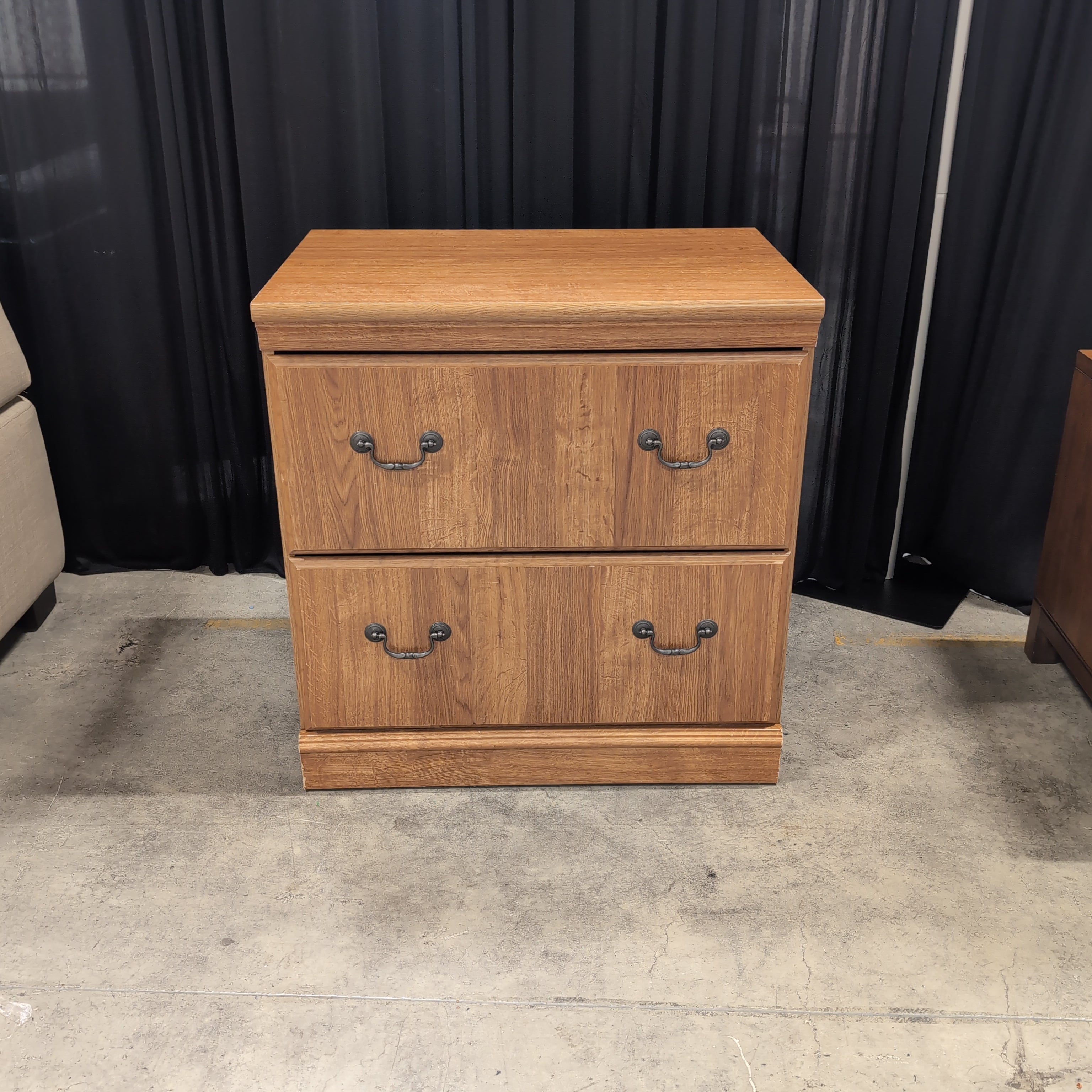 Brown Wood Three-Drawer Dresser with Dark Metal Pulls