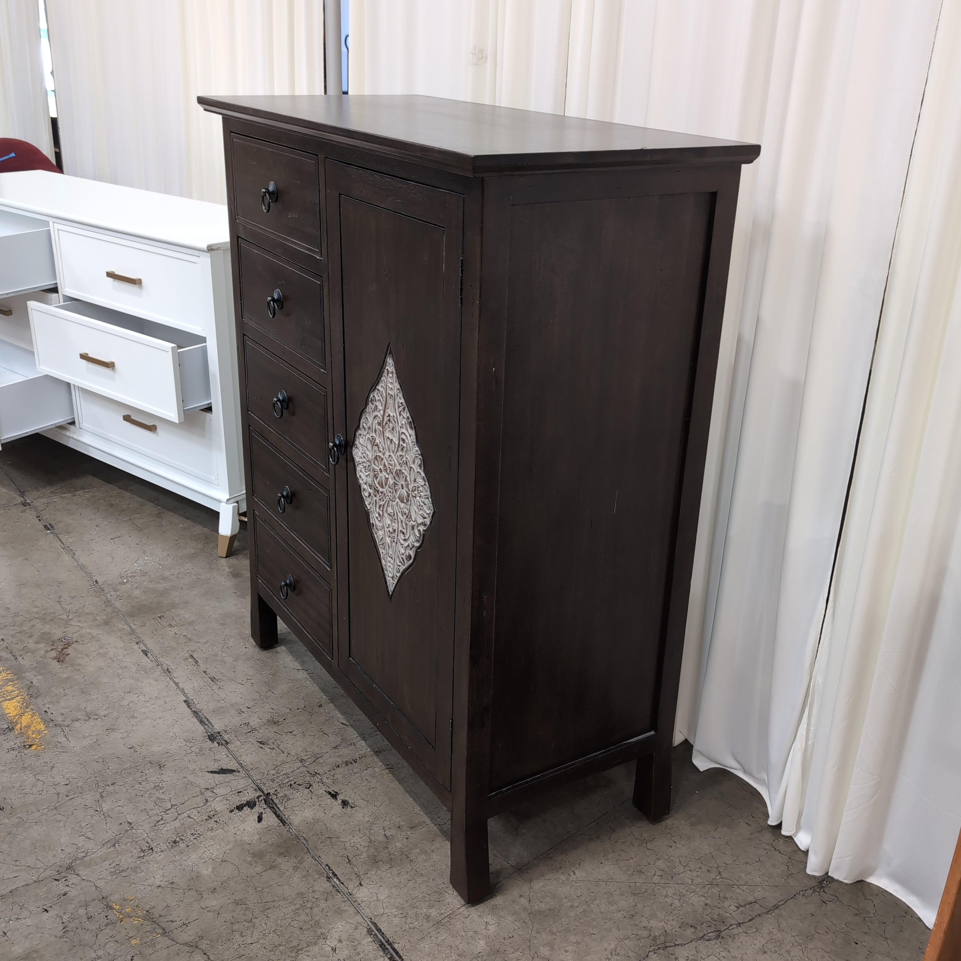 Dark Wood Five-Drawer Dresser with Ornate Panel