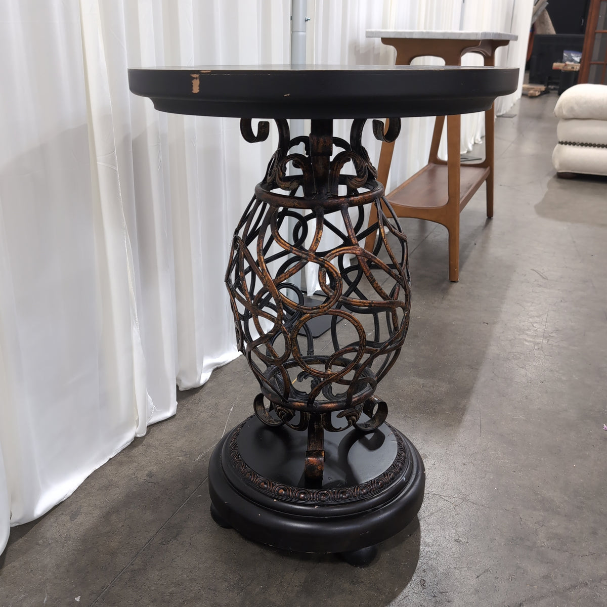 Round Dark Wood End Table with Ornate Metal Base