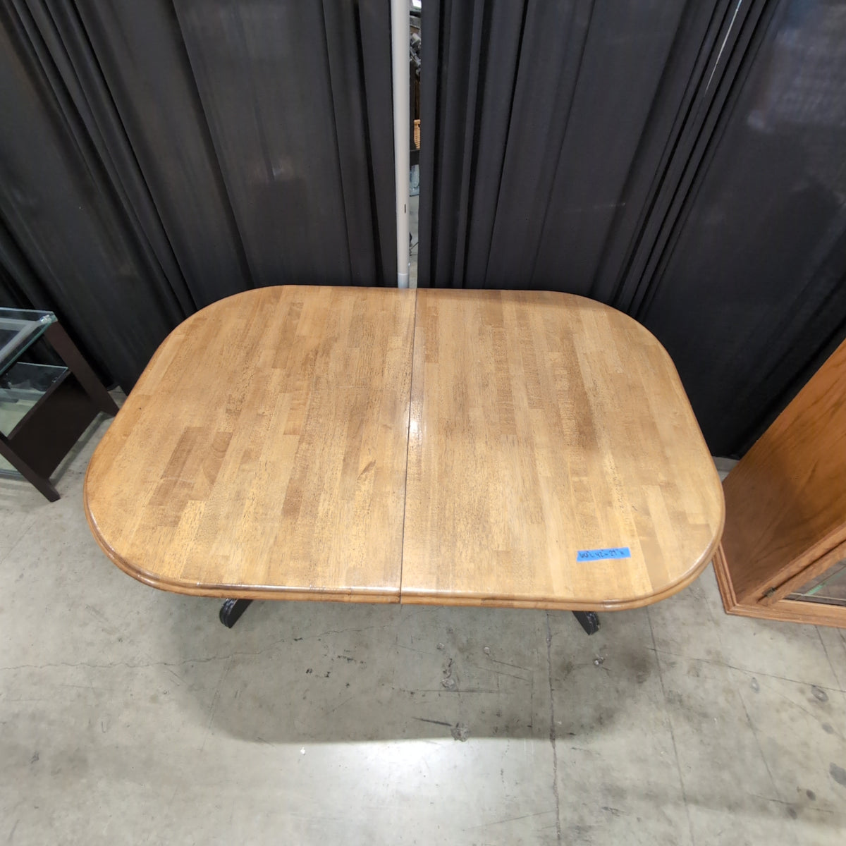 Light Wood Oval Dining Table with Dark Pedestal Base