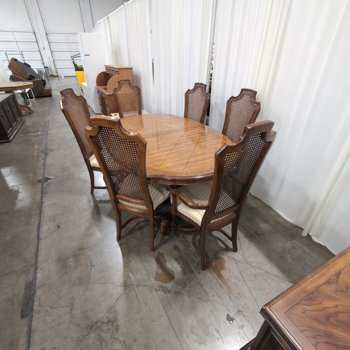 Ornate Brown Wood Dining Table With Six Cane Back Chairs