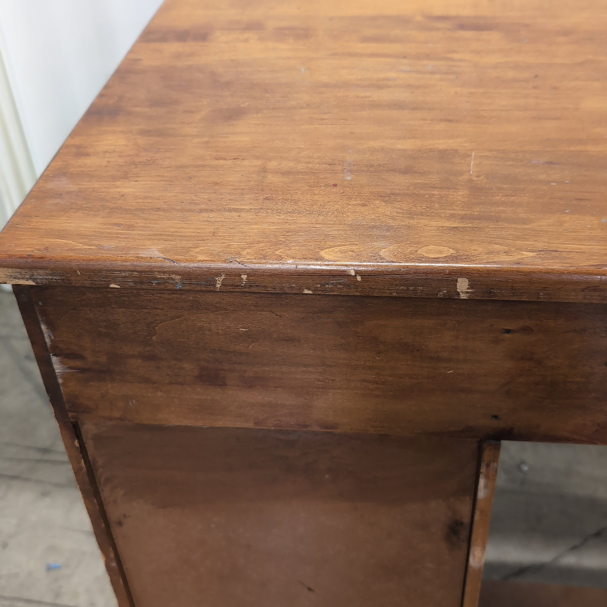 Brown Wood Four-Drawer Desk with Round Knobs