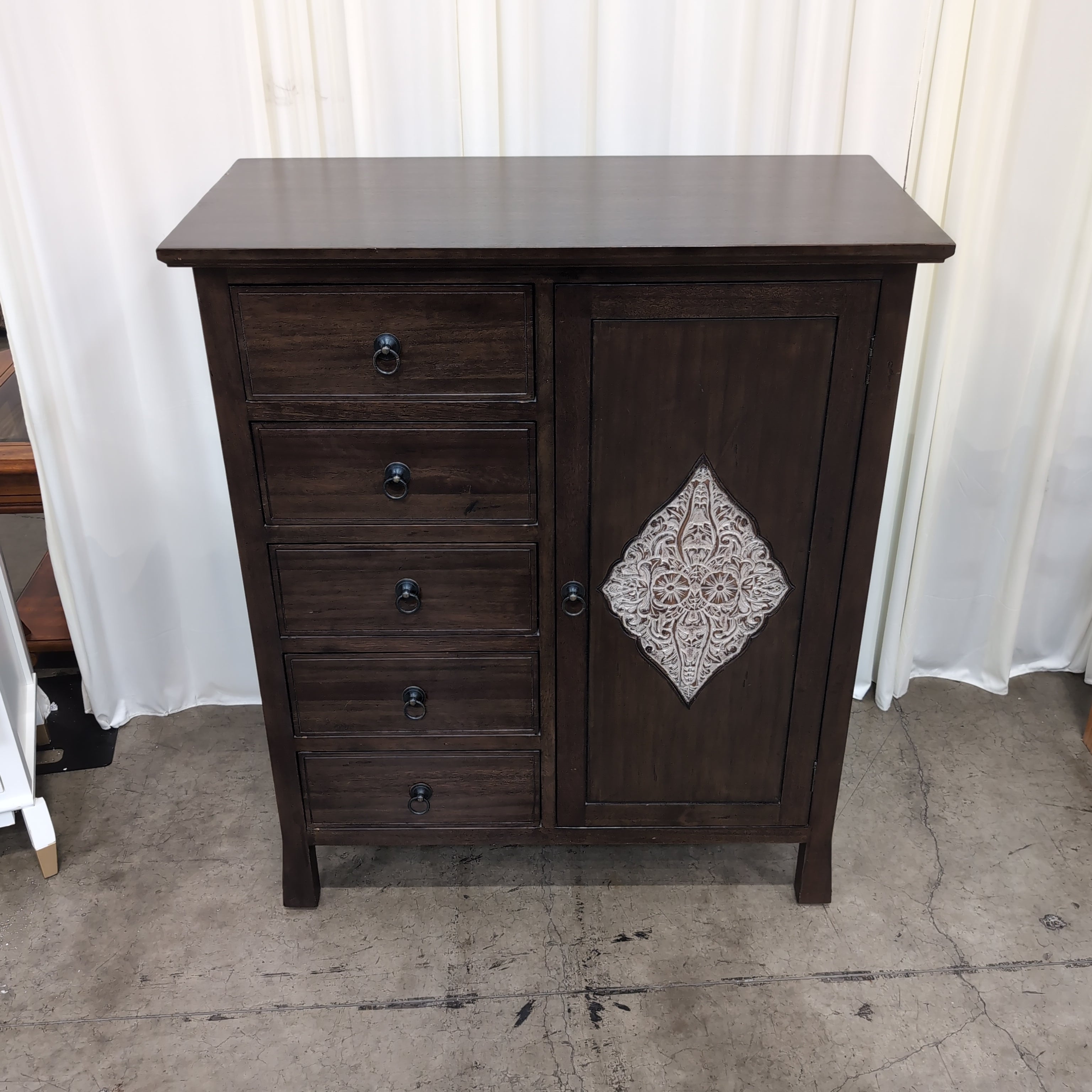 Dark Wood Five-Drawer Dresser with Ornate Panel