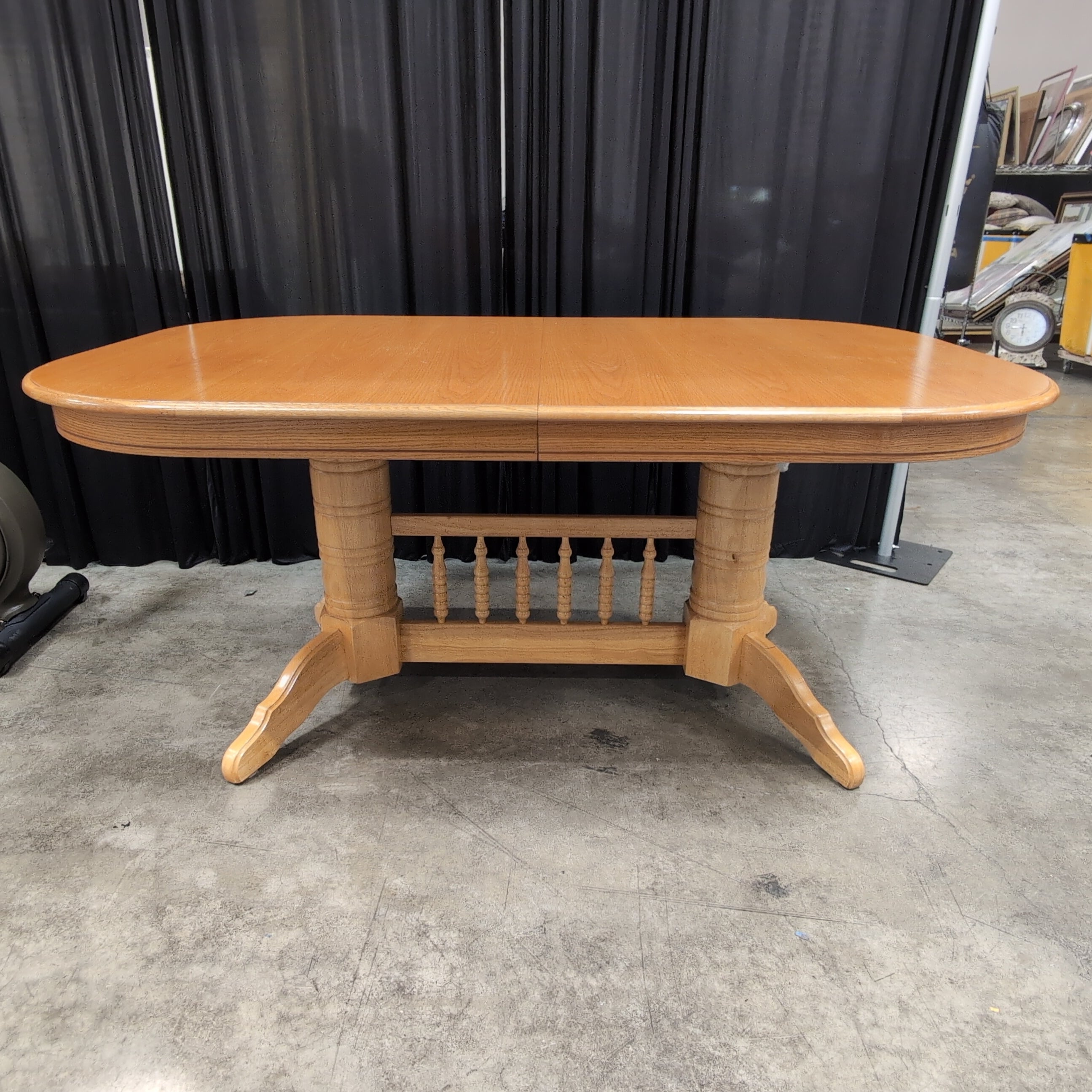 Light Wood Oval Top Dining Table with Spindle Back Chairs