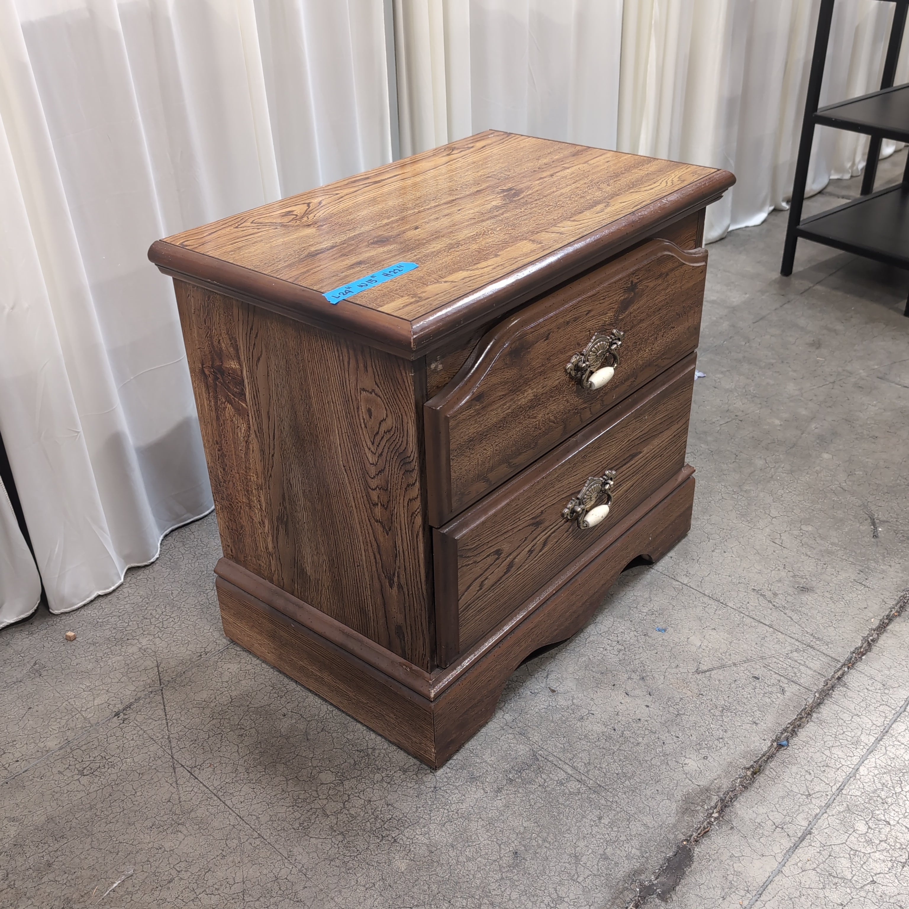 Brown Two-Drawer Wood Nightstand with Ornate Pulls