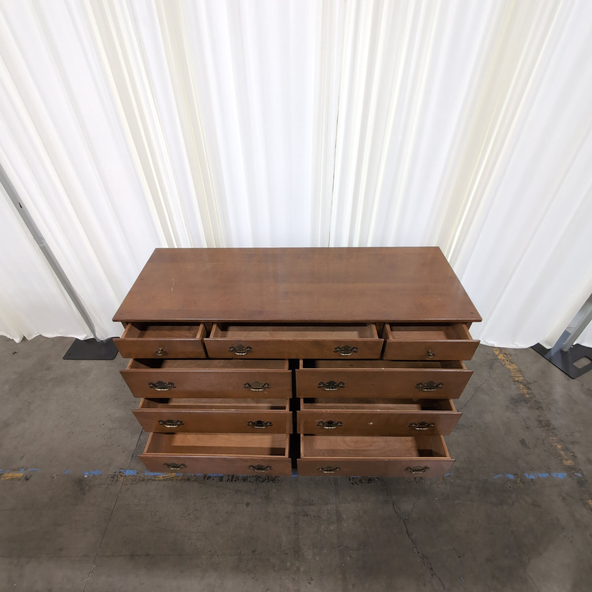Brown Wood Nine-Drawer Dresser with Ornate Hardware