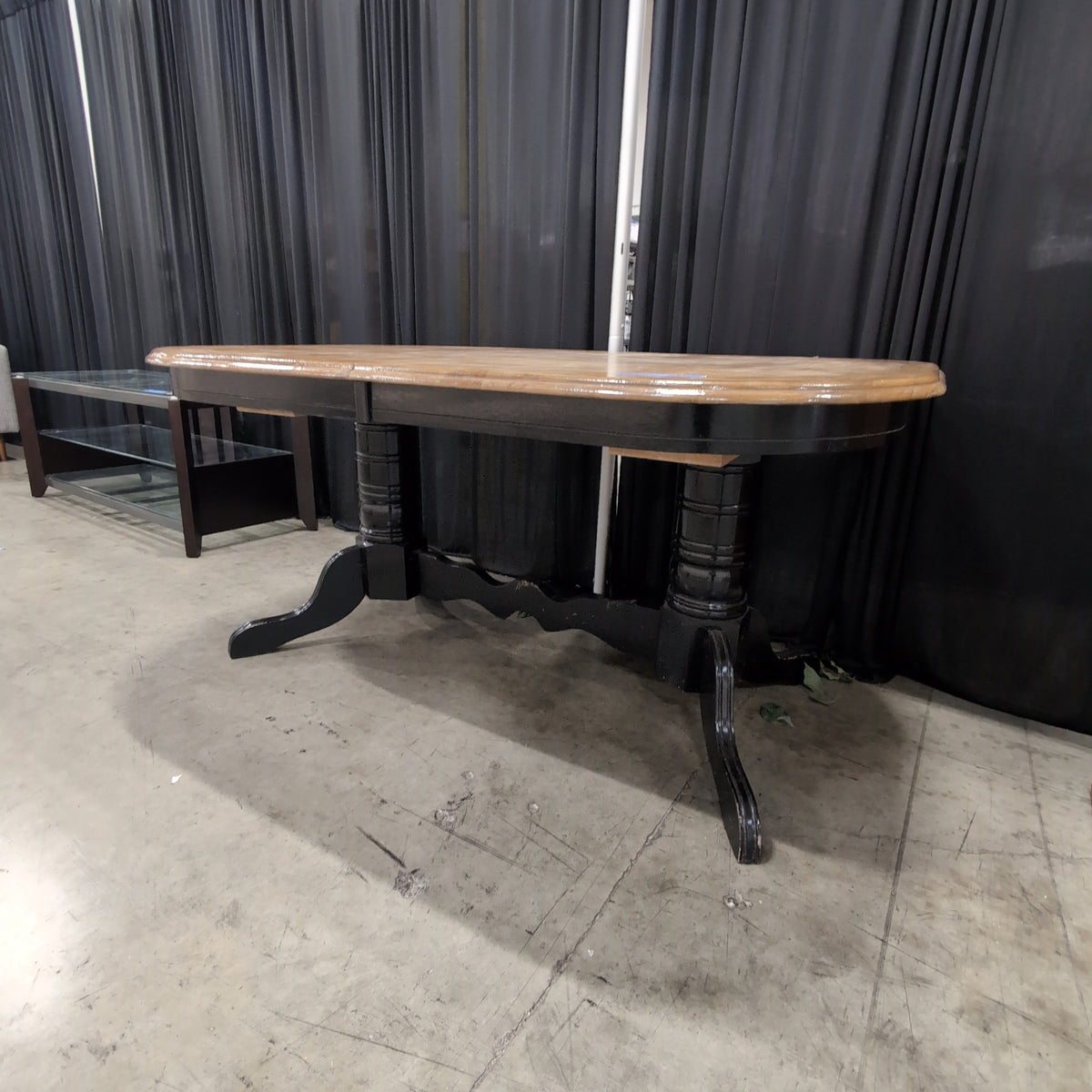 Light Wood Oval Dining Table with Dark Pedestal Base