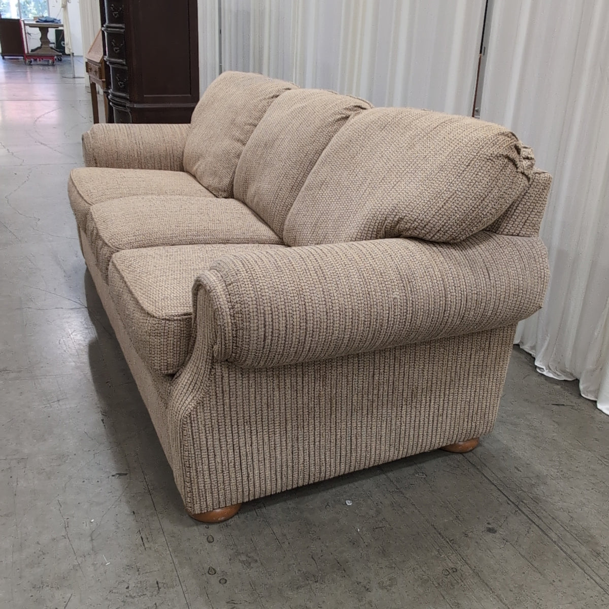 Tan Textured Fabric Three-Cushion Couch with Rolled Arms