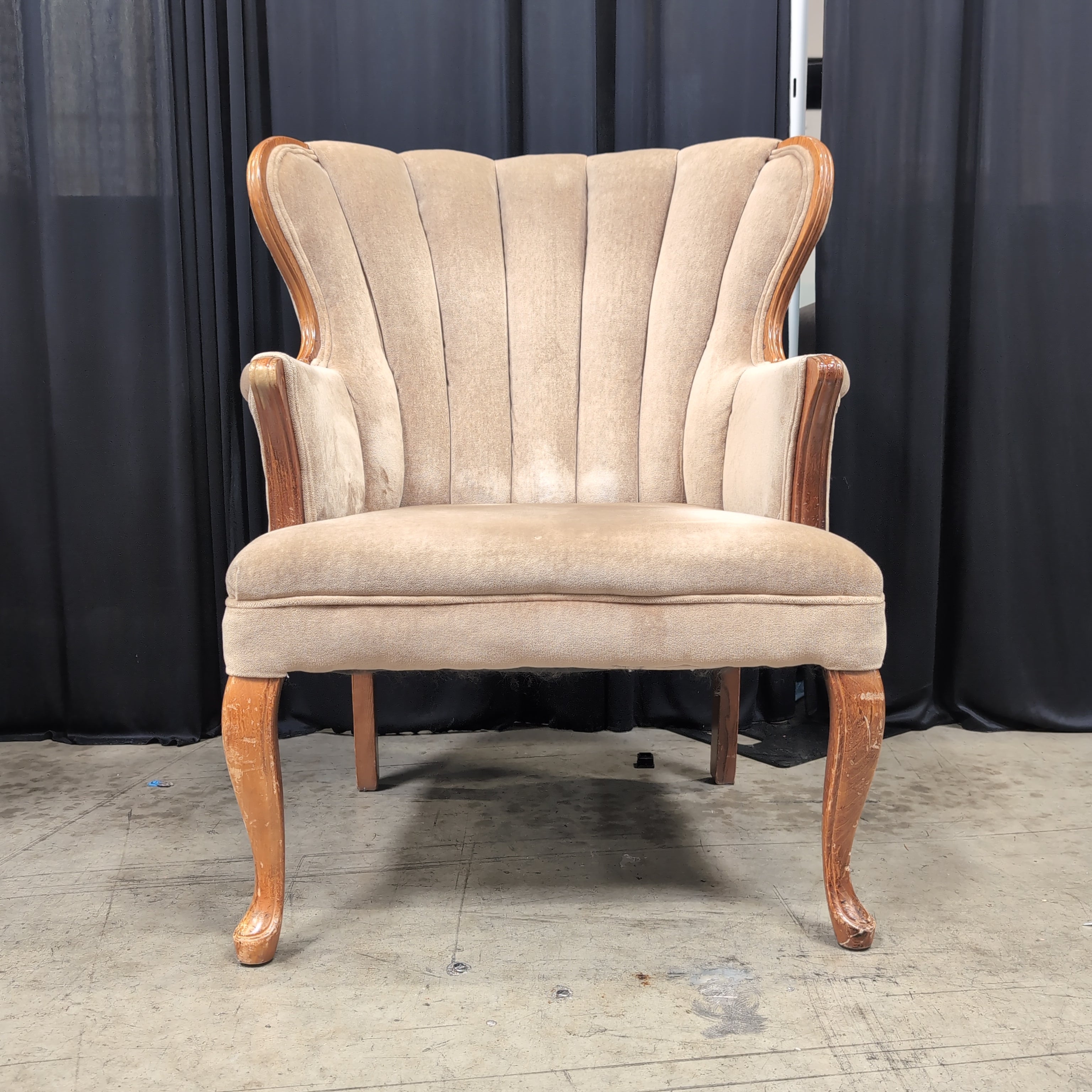 Tan Upholstered Shell Back Armchair with Carved Wood