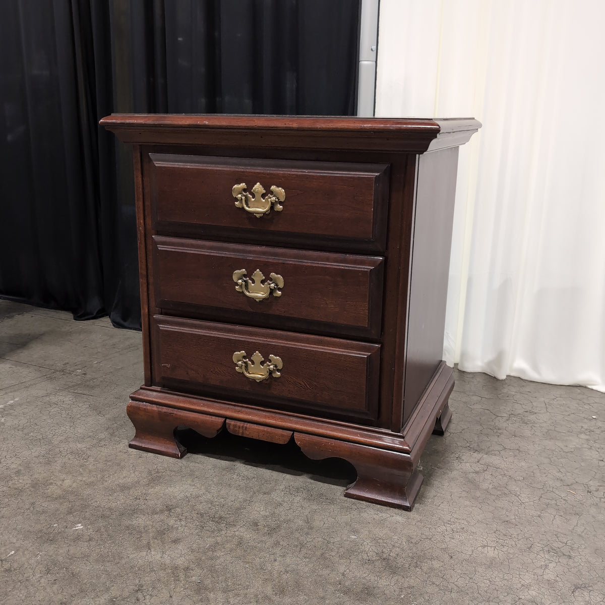 Dark Cherry Wood Nightstand with Ornate Hardware
