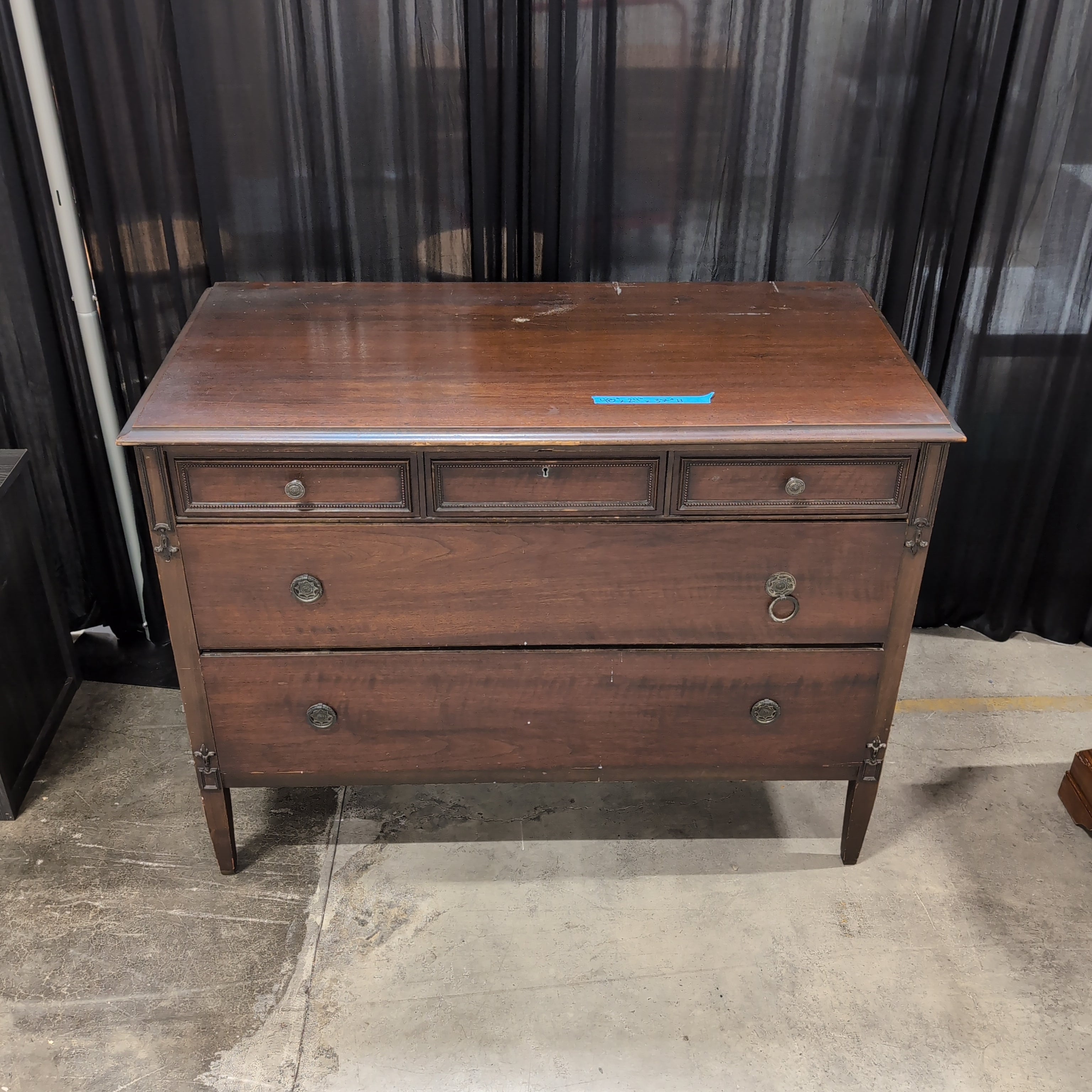 Dark Wood Three-Drawer Dresser with Recessed Panels