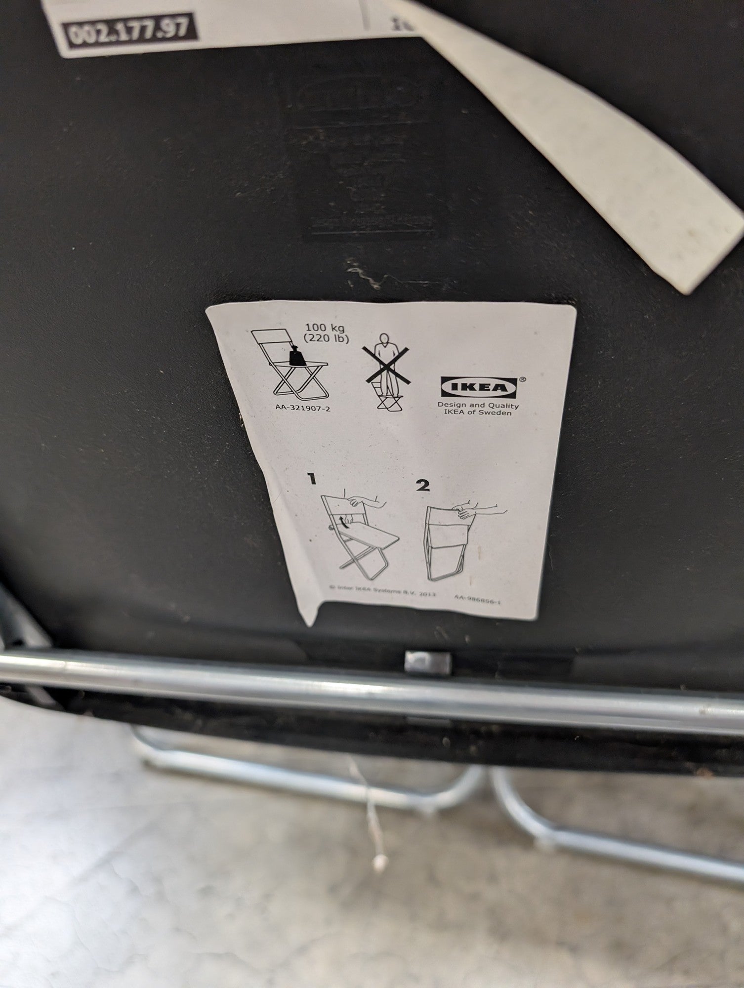 Five Black IKEA Folding Chairs with Cutout Handles