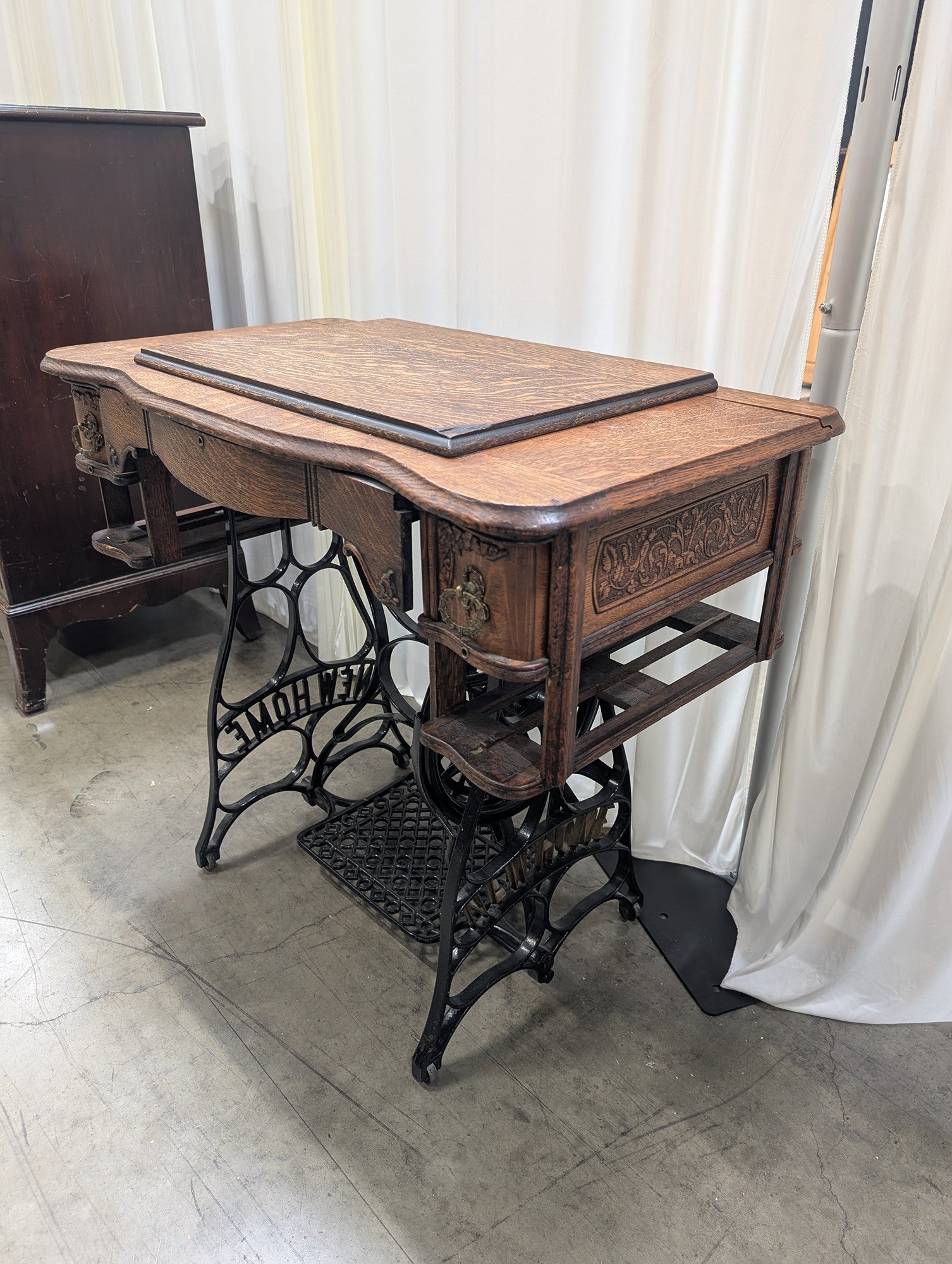 Antique NEW HOME Wood Sewing Machine Cabinet with Ornate Cast Iron Base