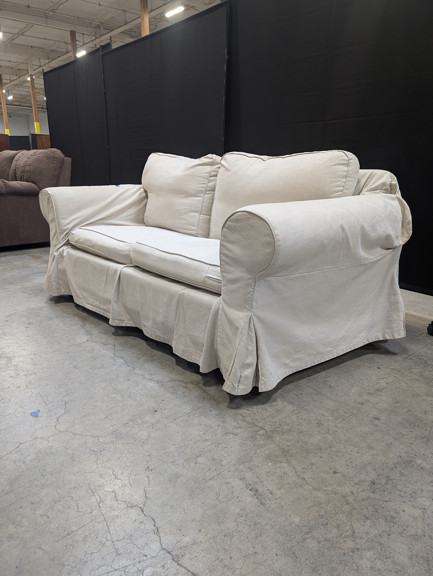 Light Beige Slipcovered Rolled Arm Couch