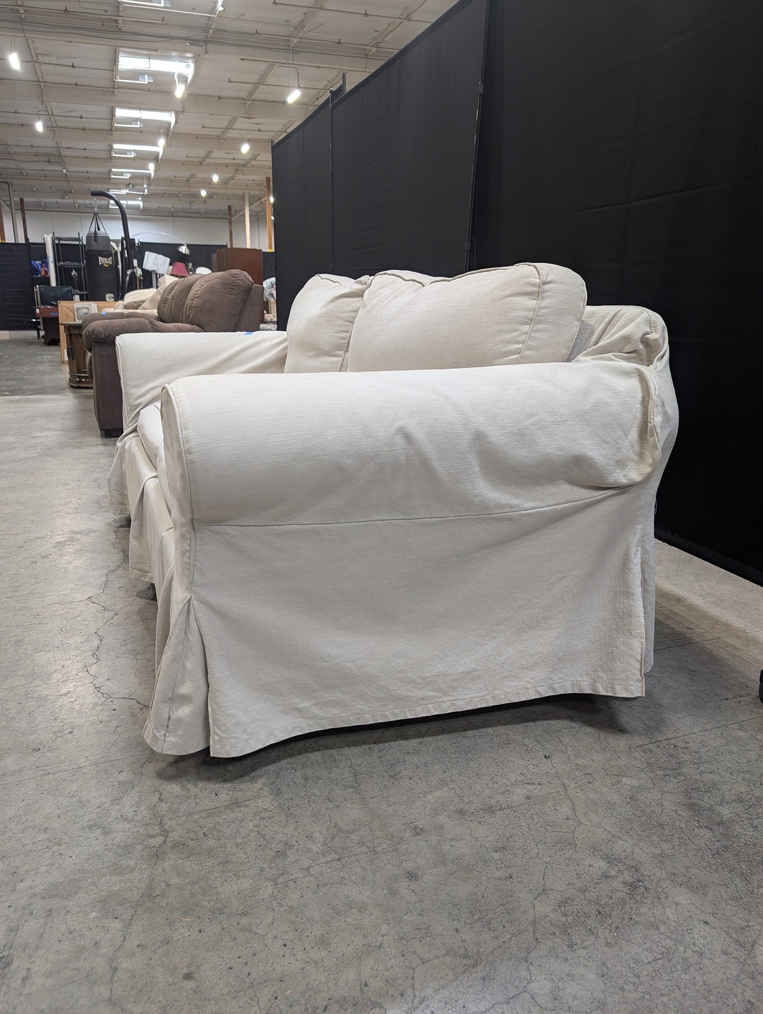 Light Beige Slipcovered Rolled Arm Couch