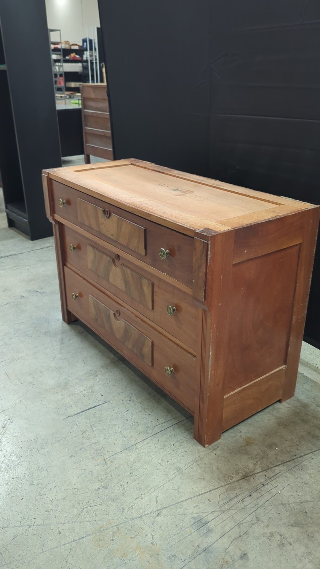 Warm Wood Three-Drawer Dresser with Ornate Hardware
