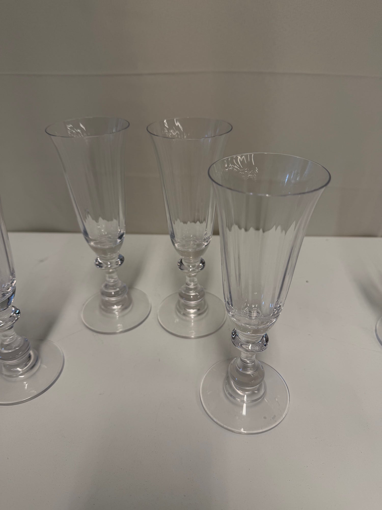 Four Clear Ribbed Glass Champagne Flutes with Decorative Stems