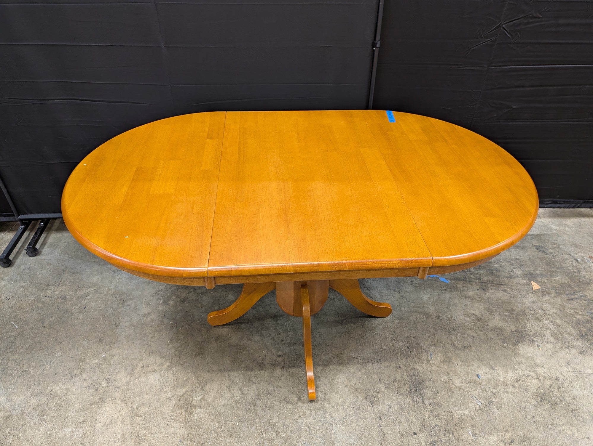 Oval Pedestal Dining Table in Warm Wood