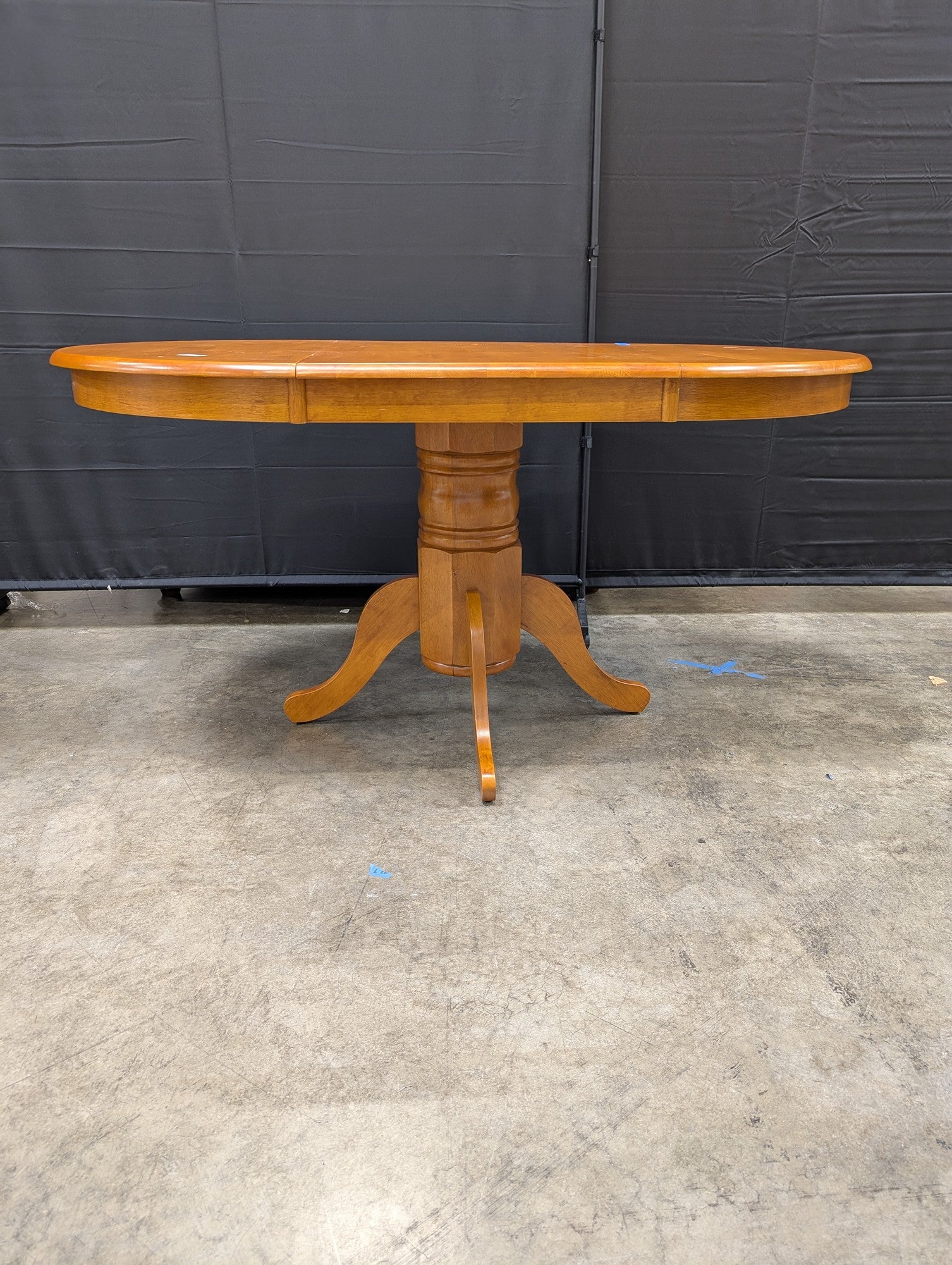 Oval Pedestal Dining Table in Warm Wood