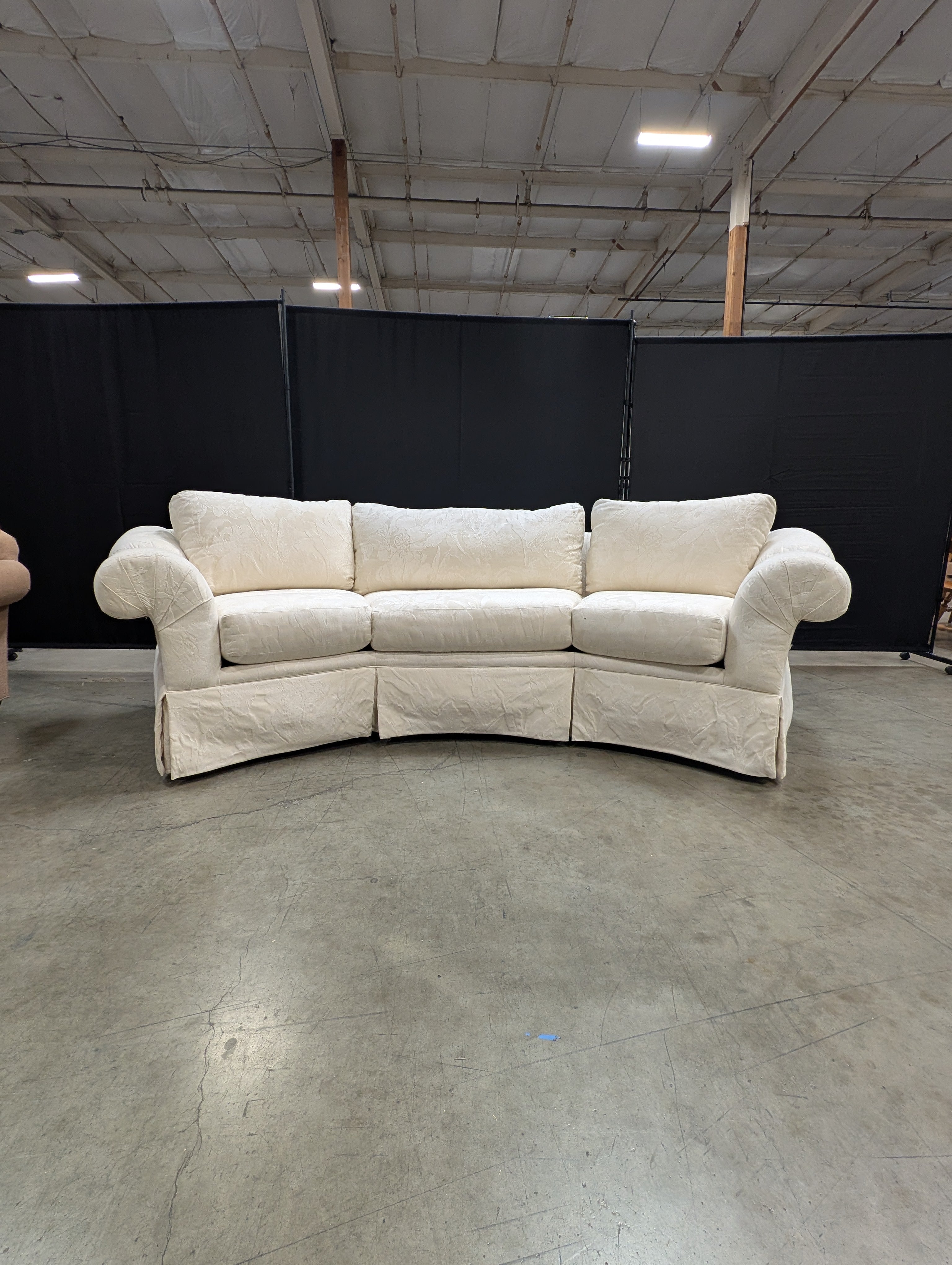 Has a stain Curved Cream Fabric Sectional Sofa with Rolled Arms