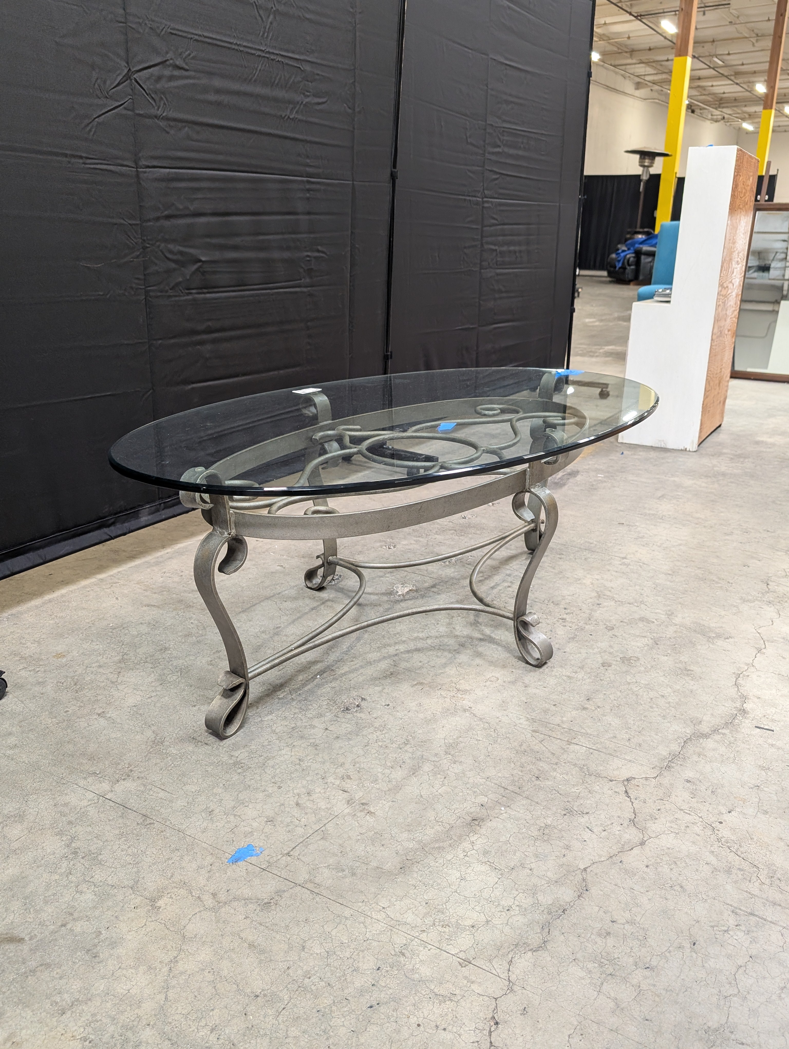 Oval Glass Top Coffee Table with Ornate Scrolled Metal Base