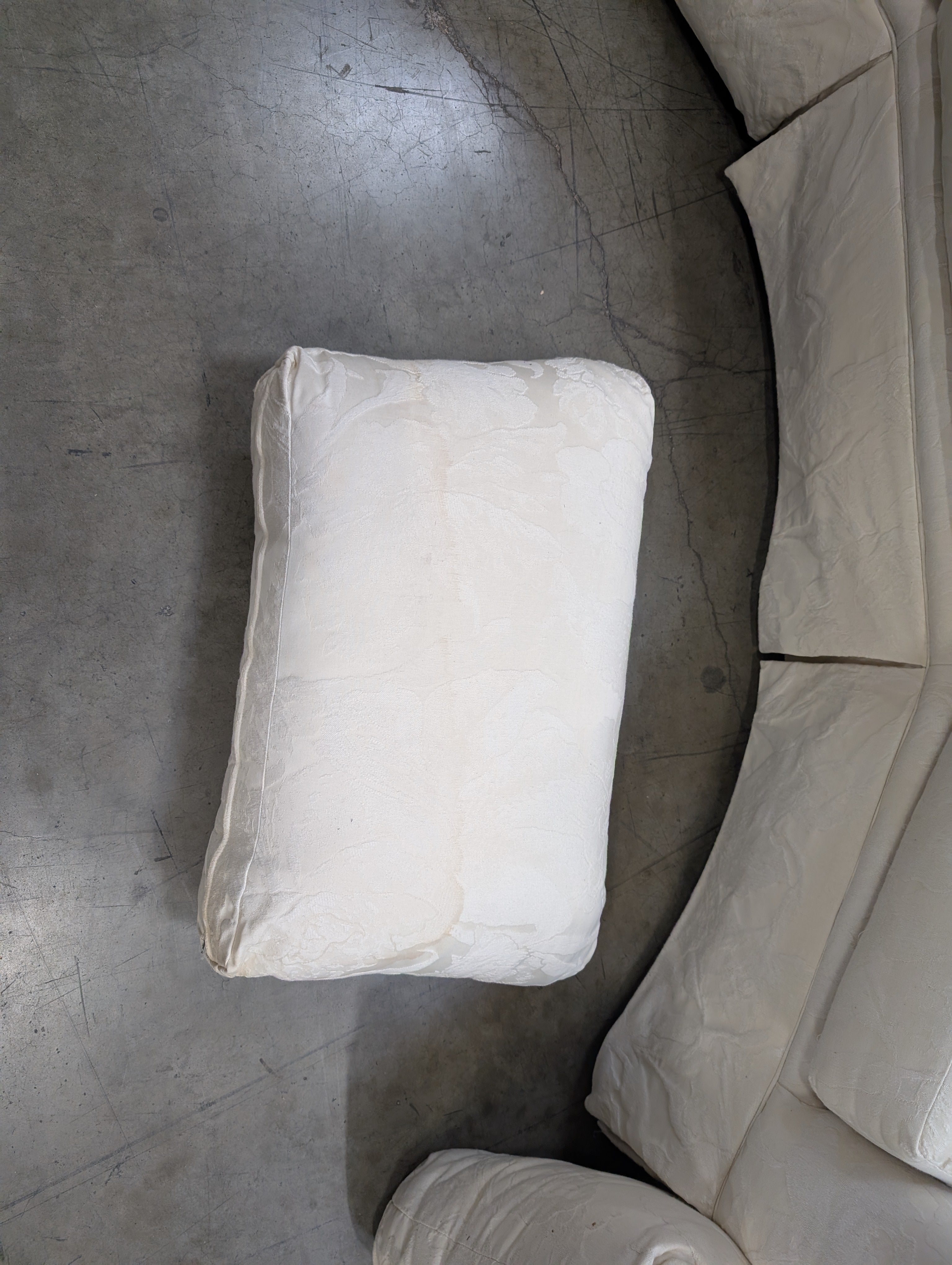 Has a stain Curved Cream Fabric Sectional Sofa with Rolled Arms