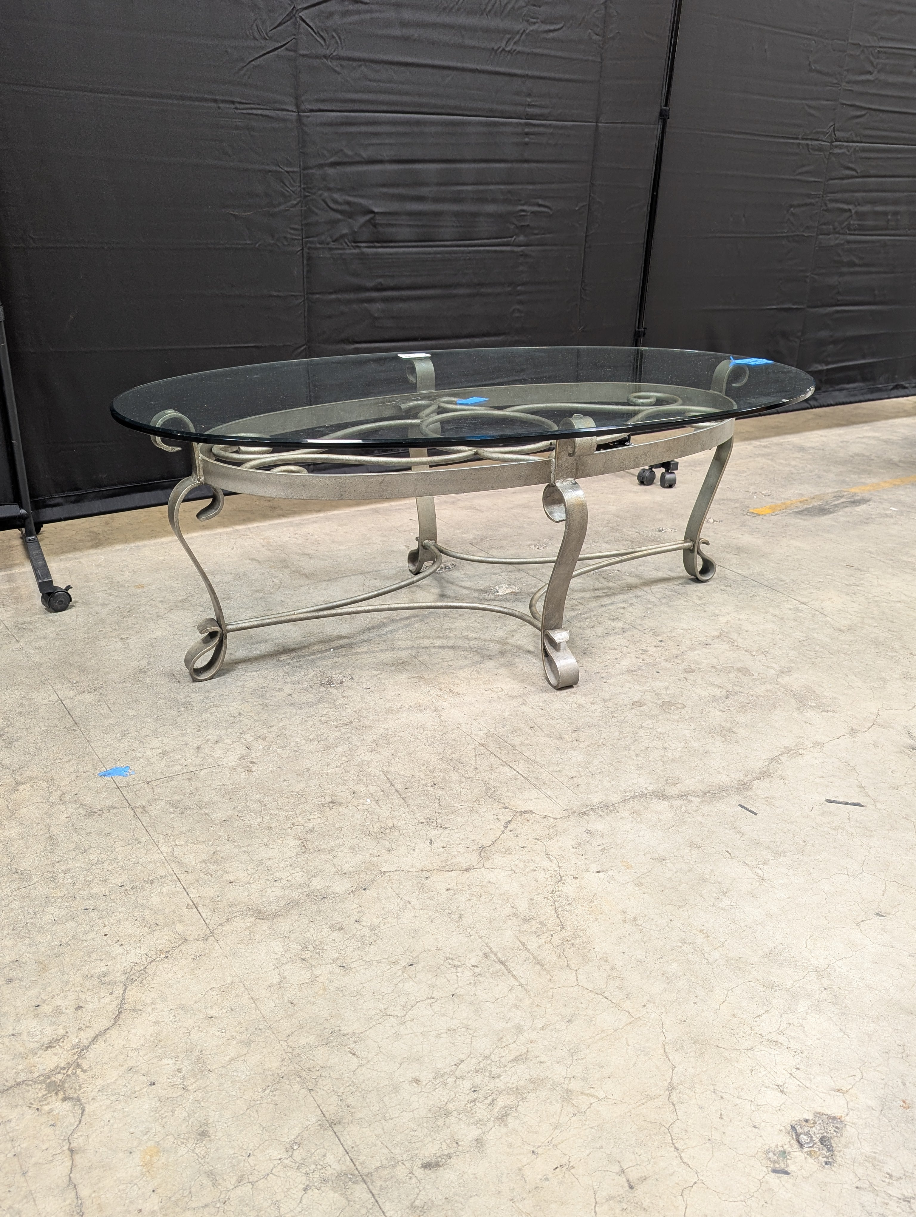 Oval Glass Top Coffee Table with Ornate Scrolled Metal Base