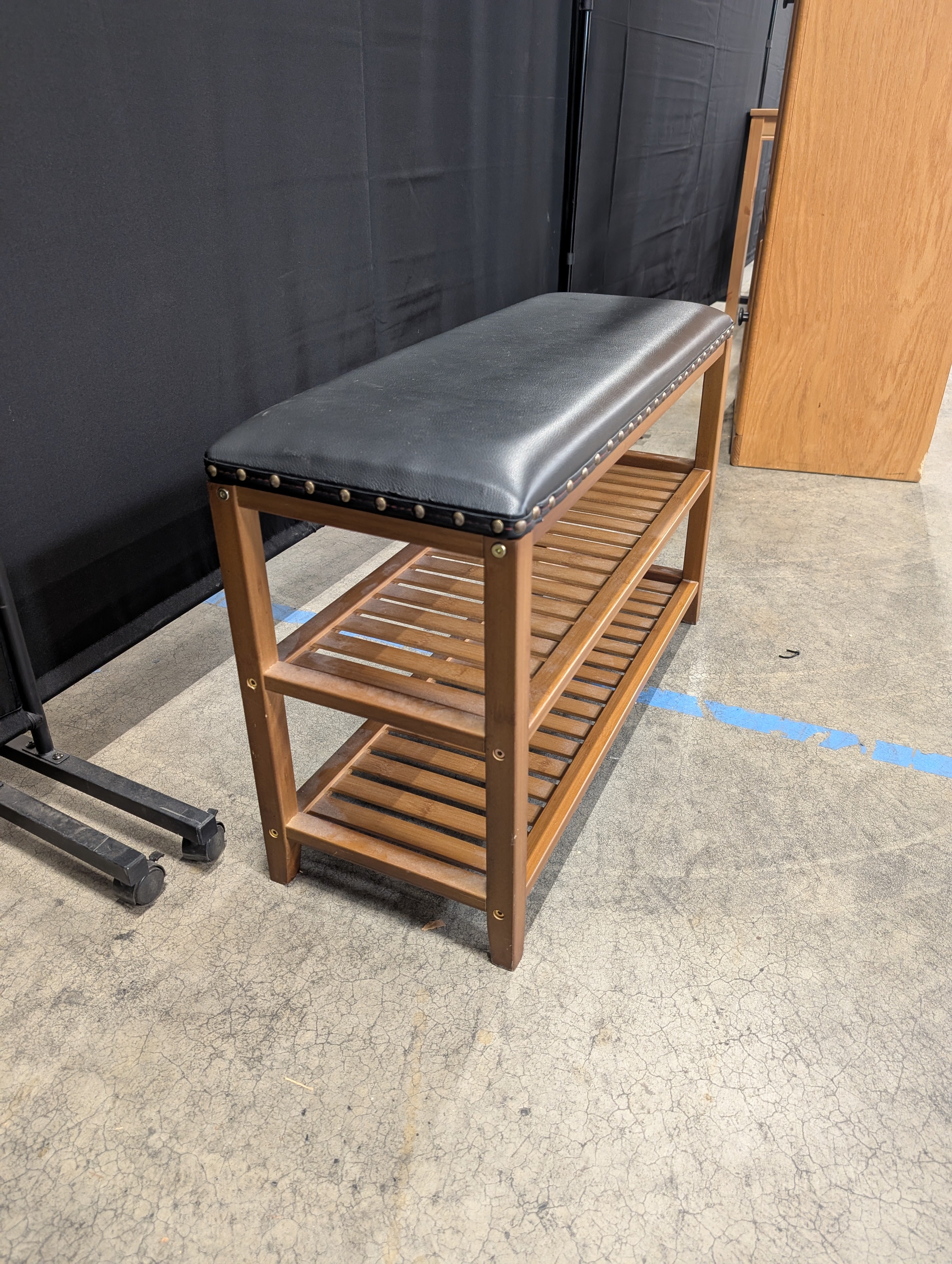 Hardwood Entryway Bench with Padded Black Upholstery and Slatted Shelves