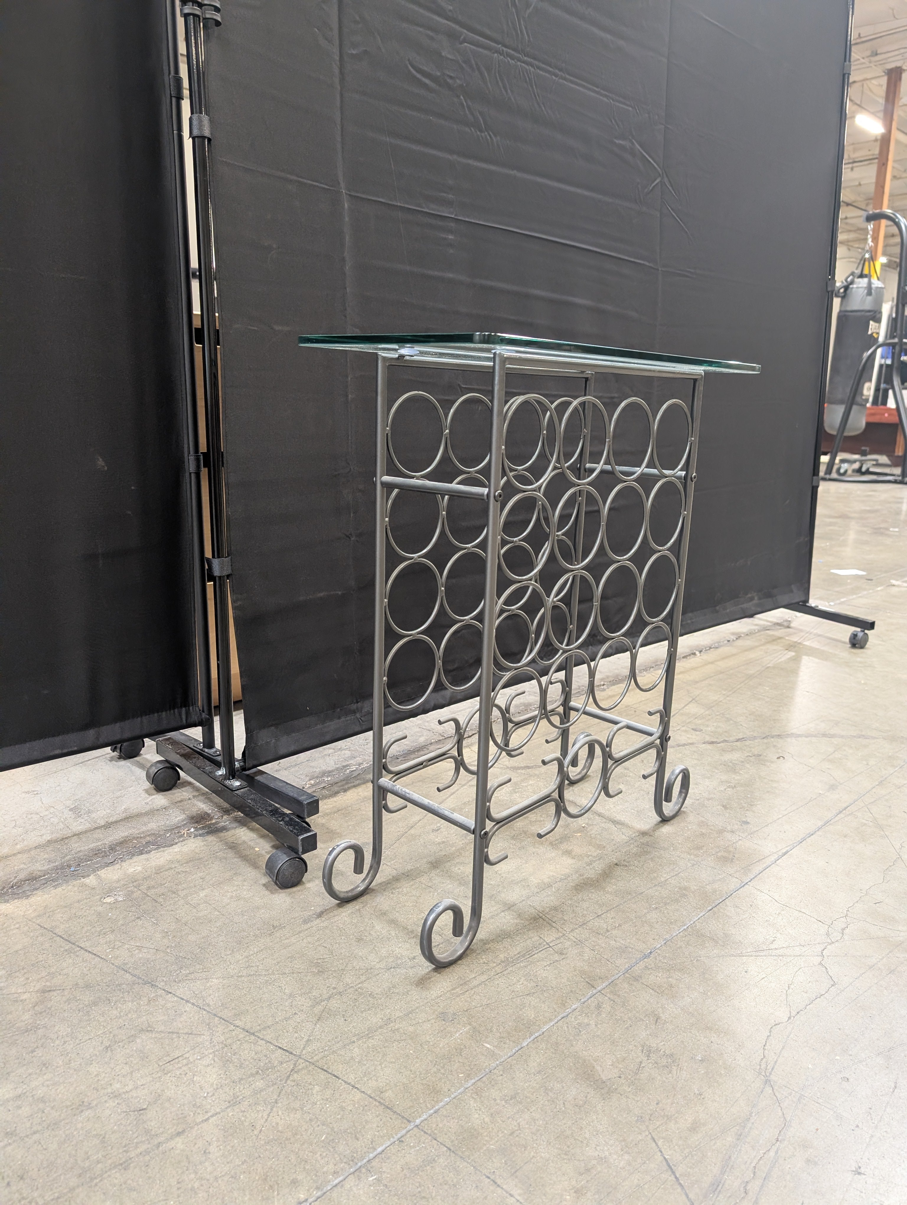 Industrial Style Metal Wine Rack with Glass Top and Wheels