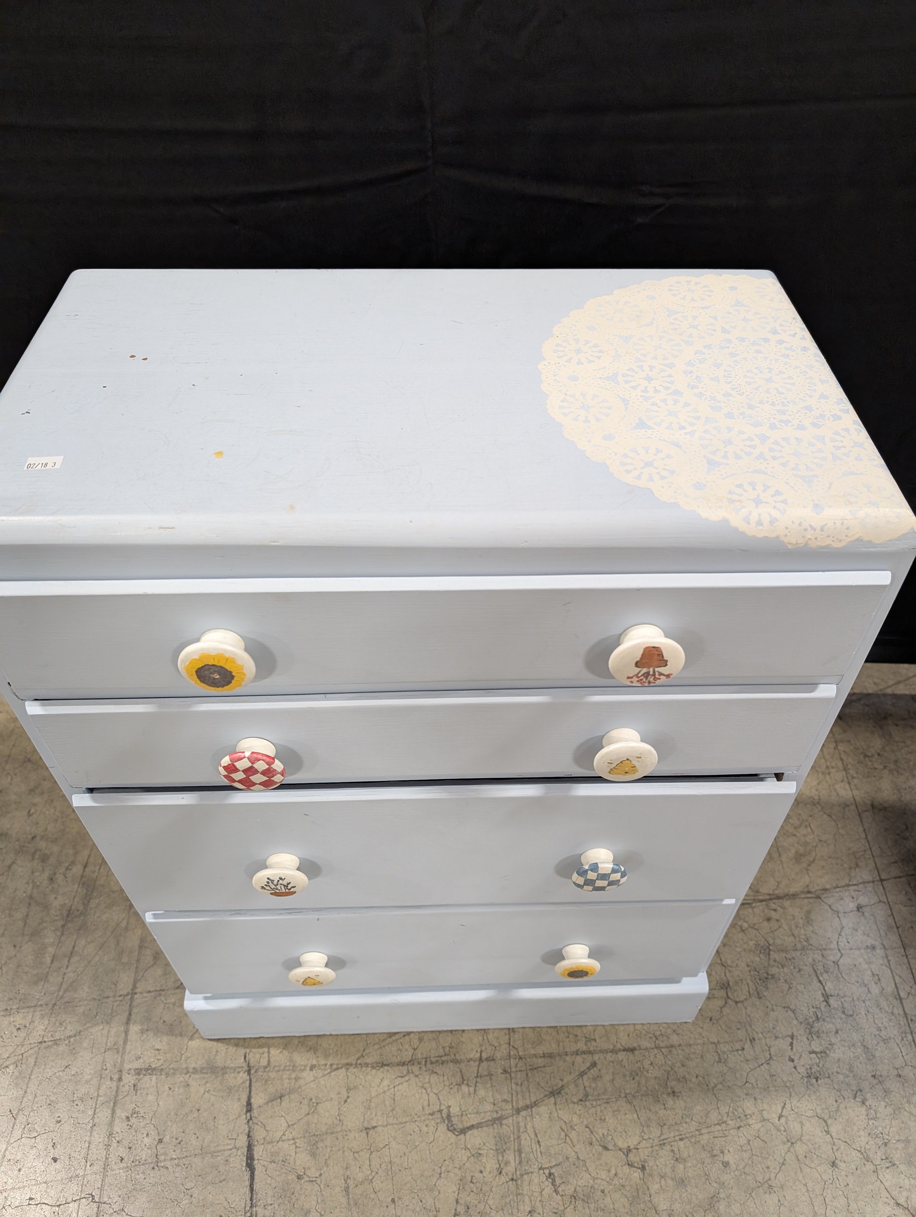 Pale Blue Wooden Four-Drawer Chest with Decorative Knobs