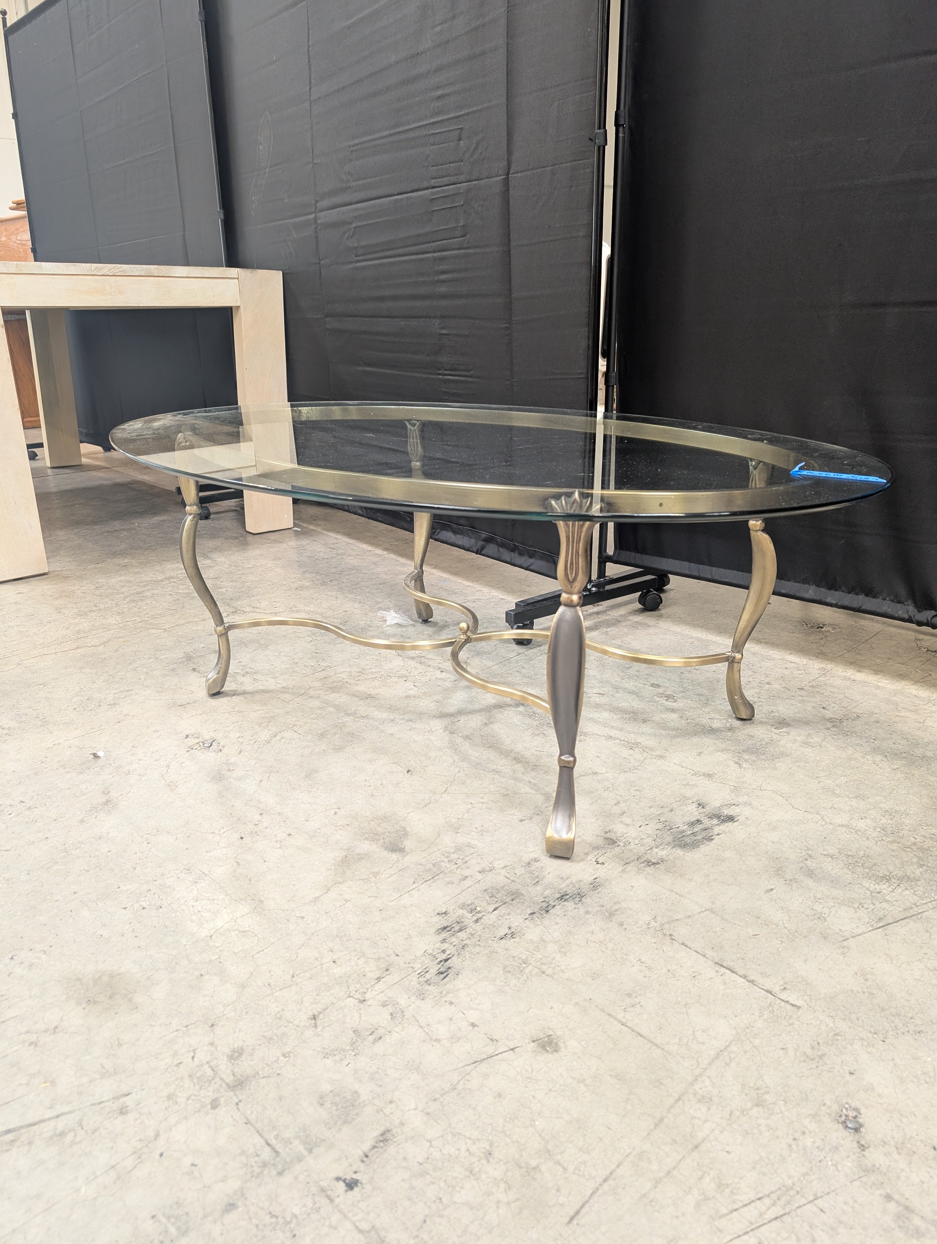 Ornate Brass-Toned Oval Coffee Table with Glass Top