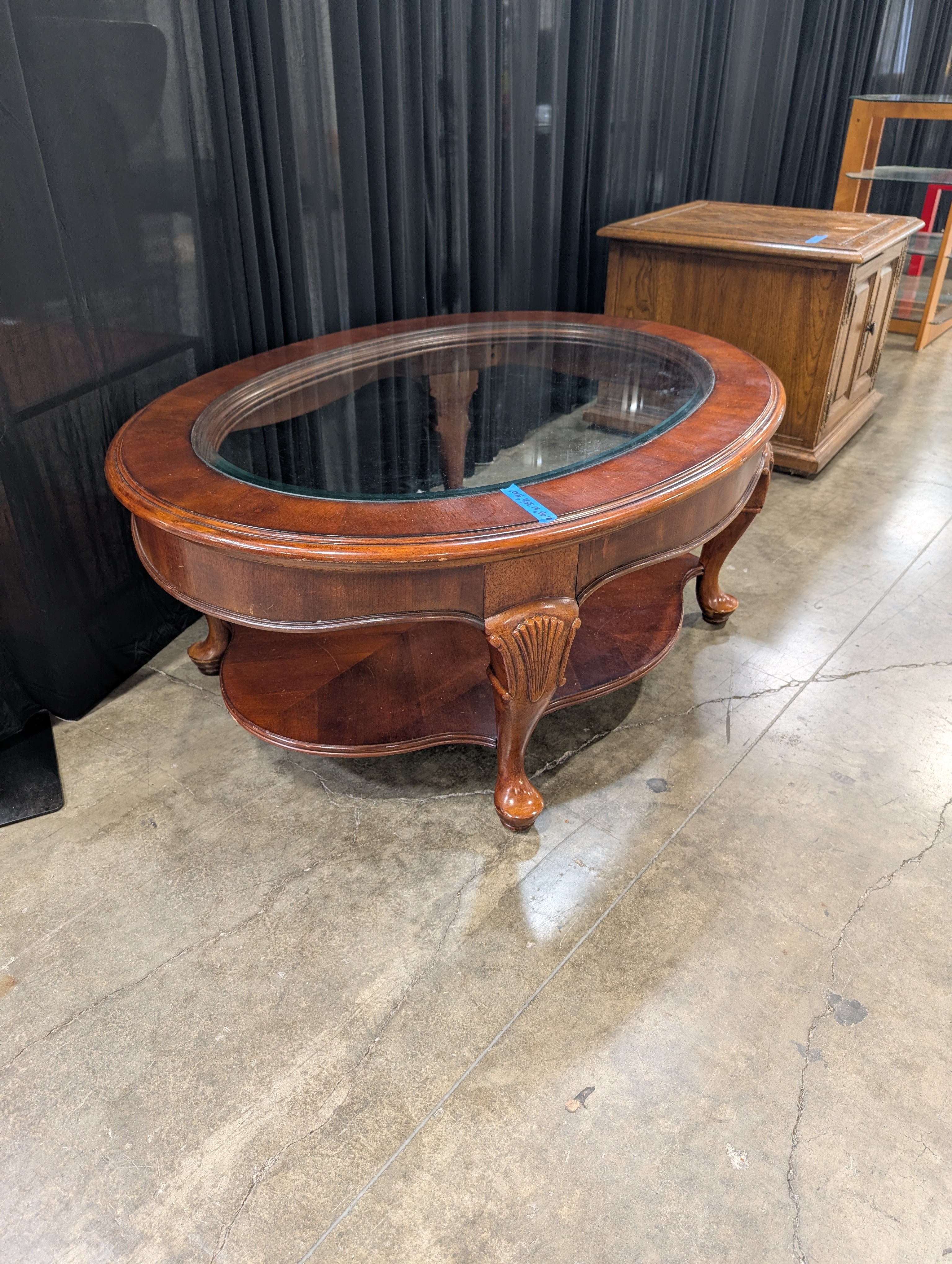 Traditional Reddish-Brown Oval Coffee Table with Glass Top