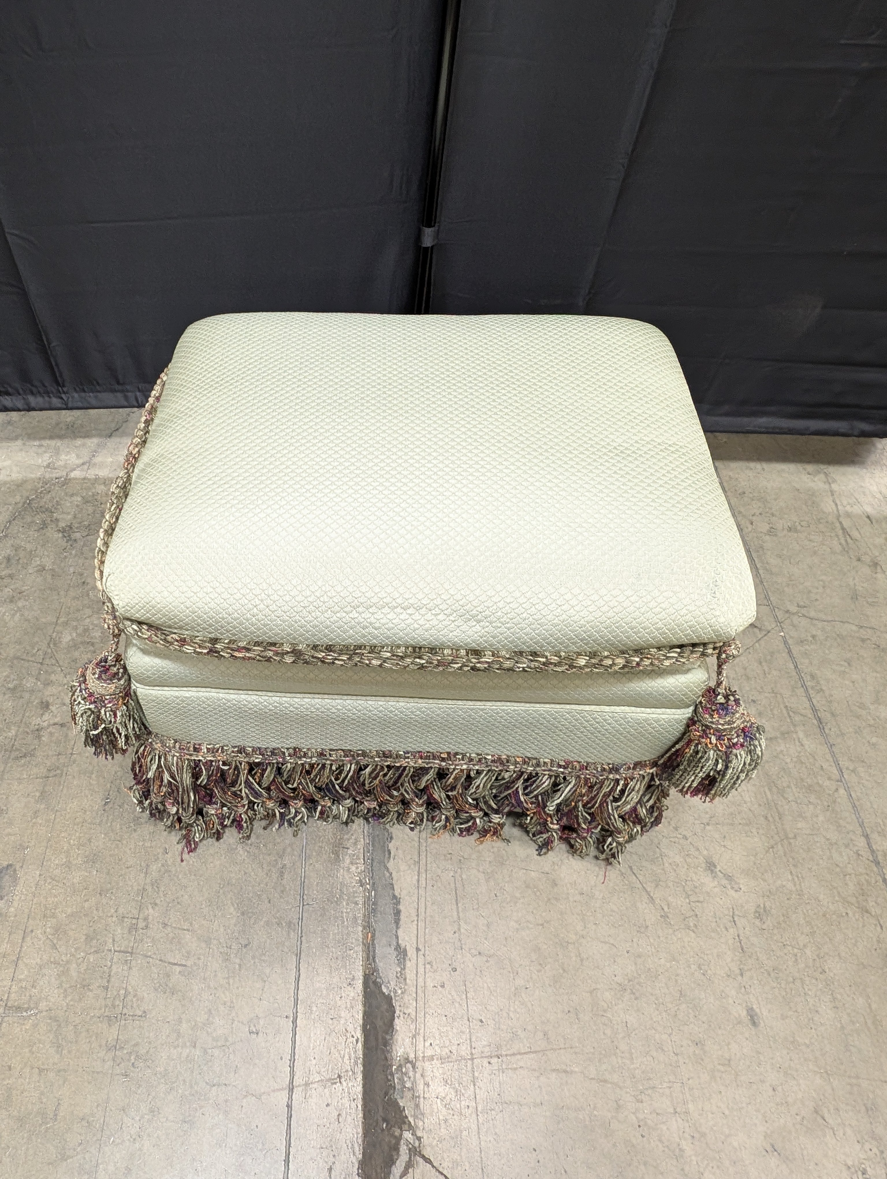 Textured Upholstered Cushion with Tassel Fringe Trim
