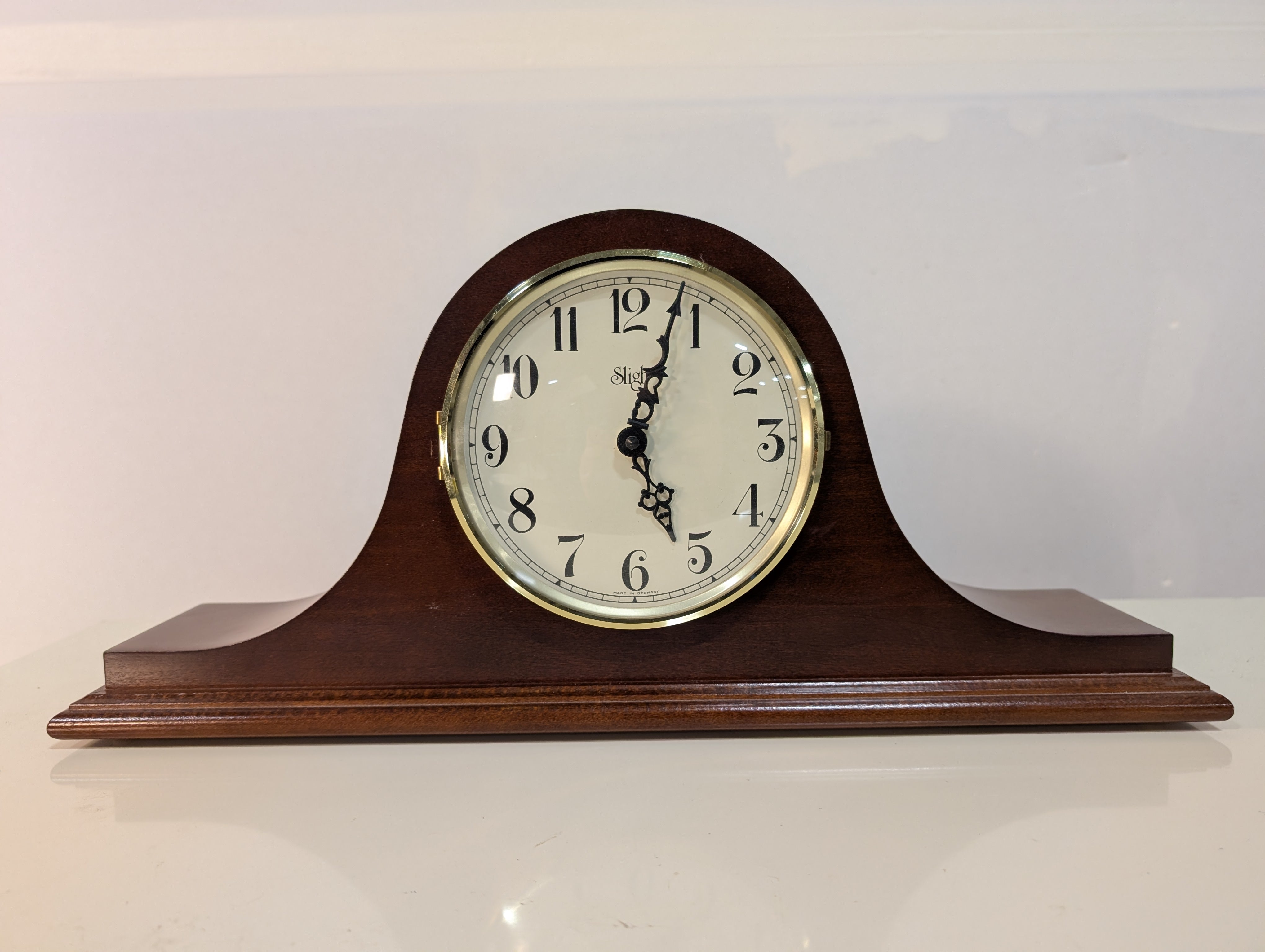 Curved Dark Wood Table Clock with Brass Tone Bezel
