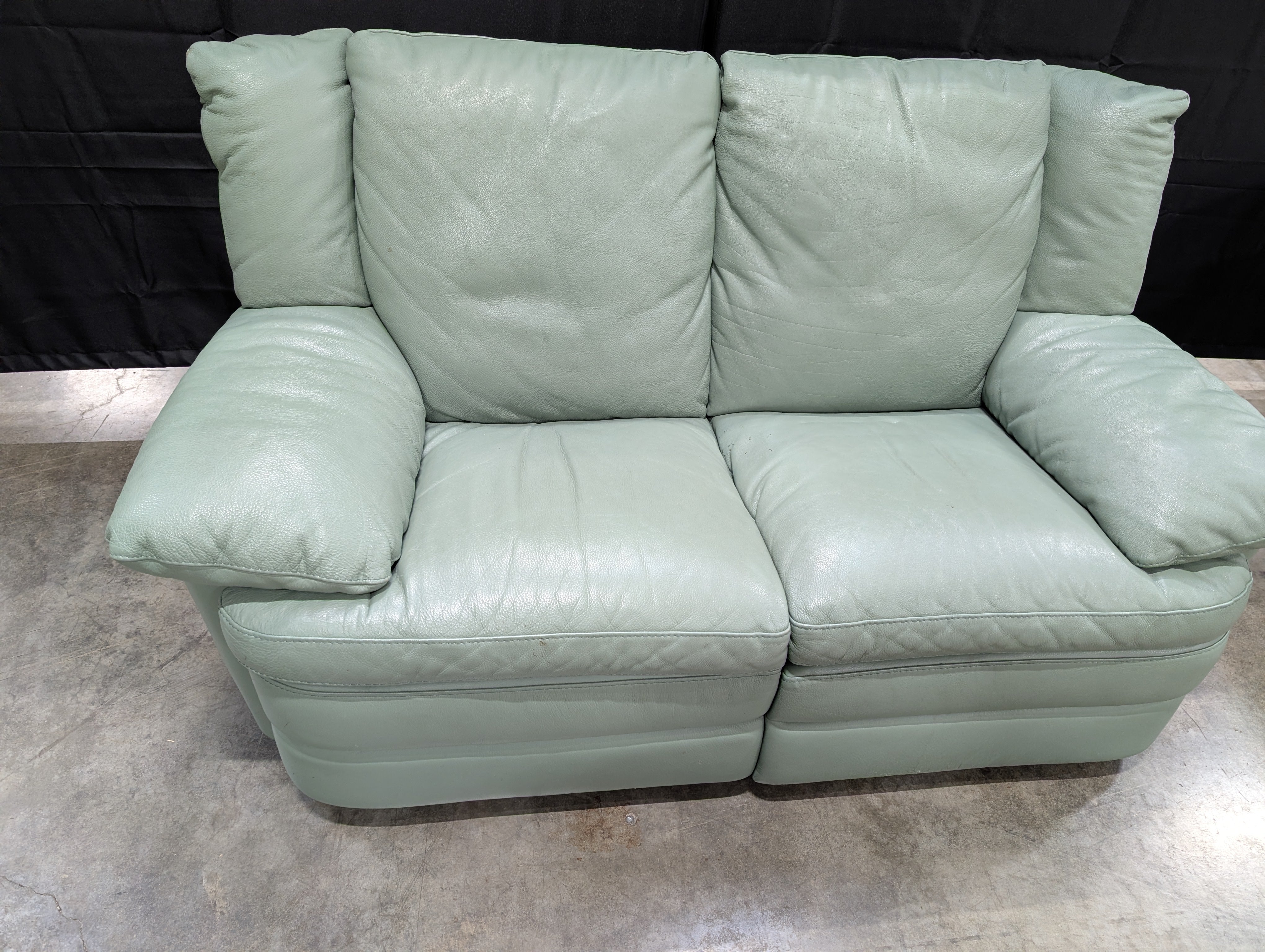 Charming Mint Green Leather Two-Seater Sofa with Plush Padded Arms