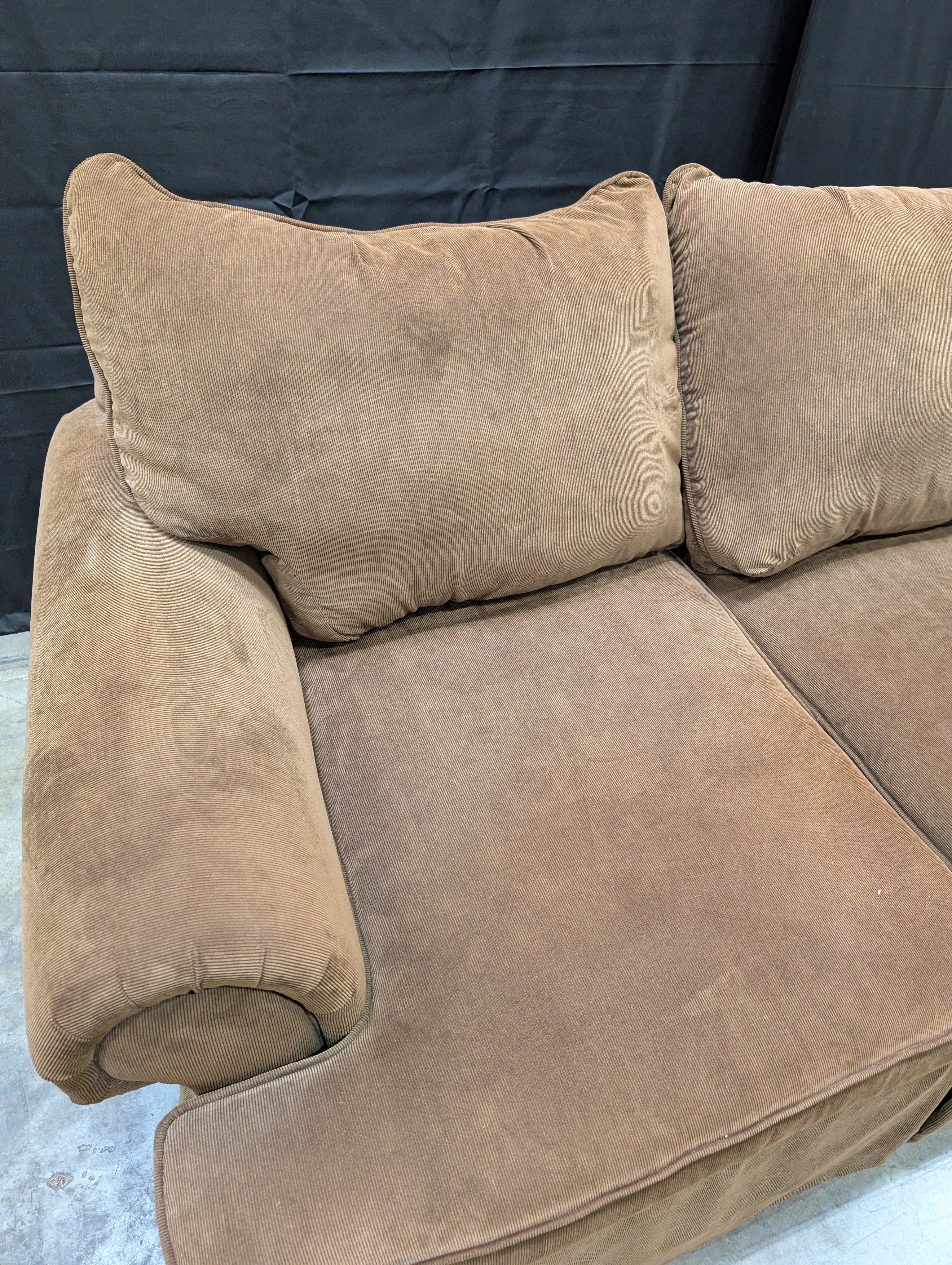 Spacious Brown Fabric Three-Seater Sofa