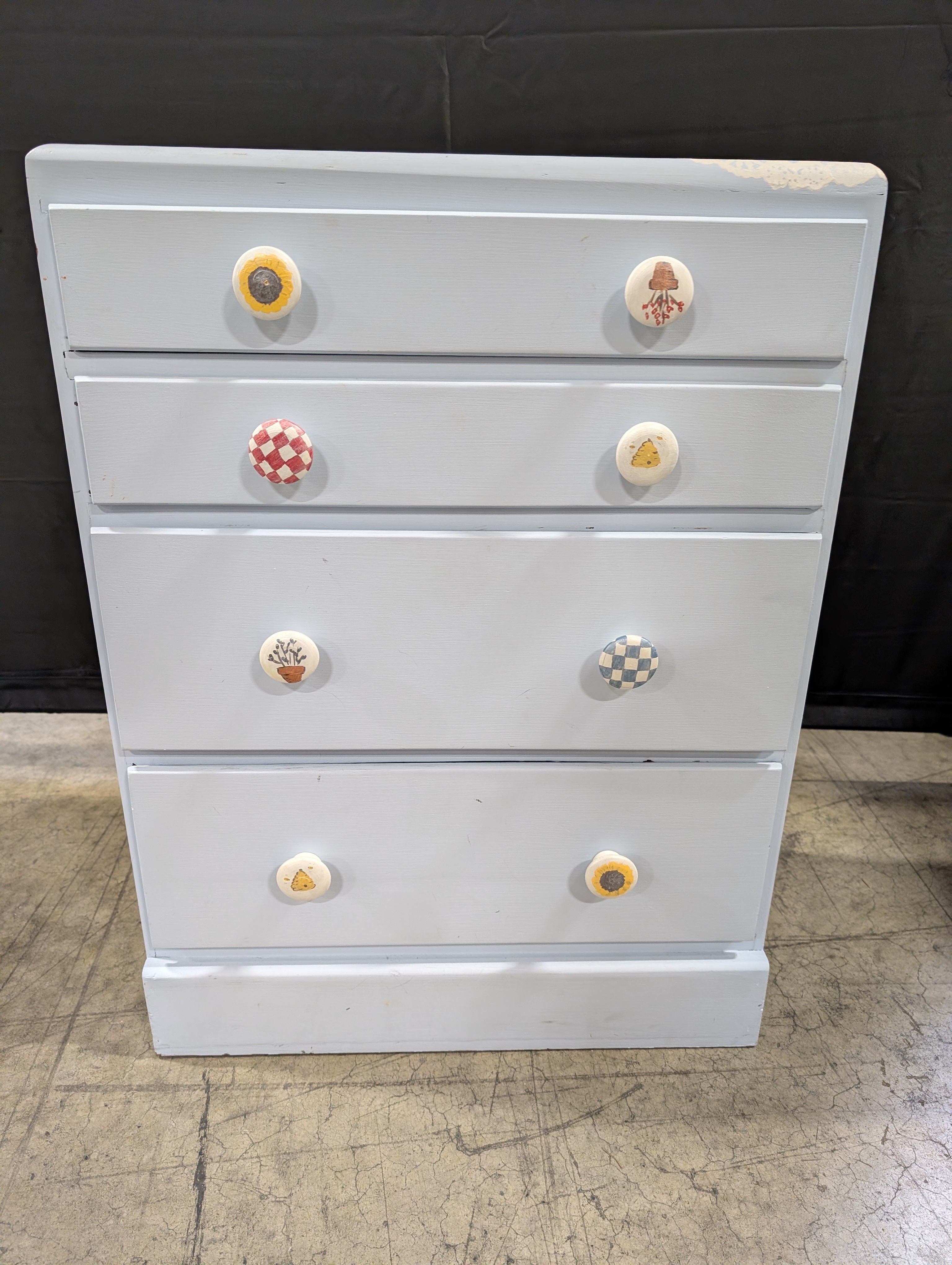 Pale Blue Wooden Four-Drawer Chest with Decorative Knobs
