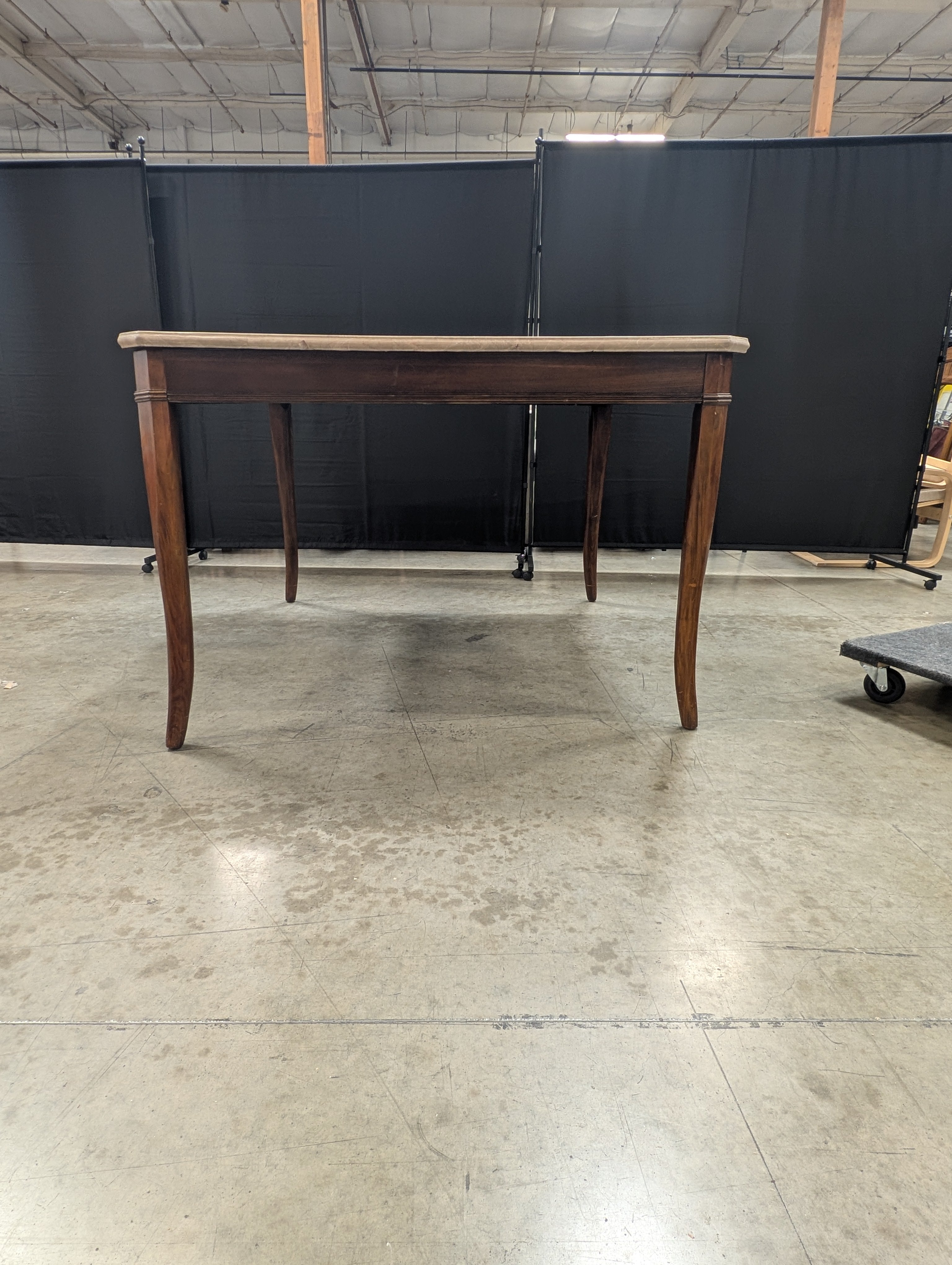 Stone Top Dining Table with Tapered Wood Legs has chip