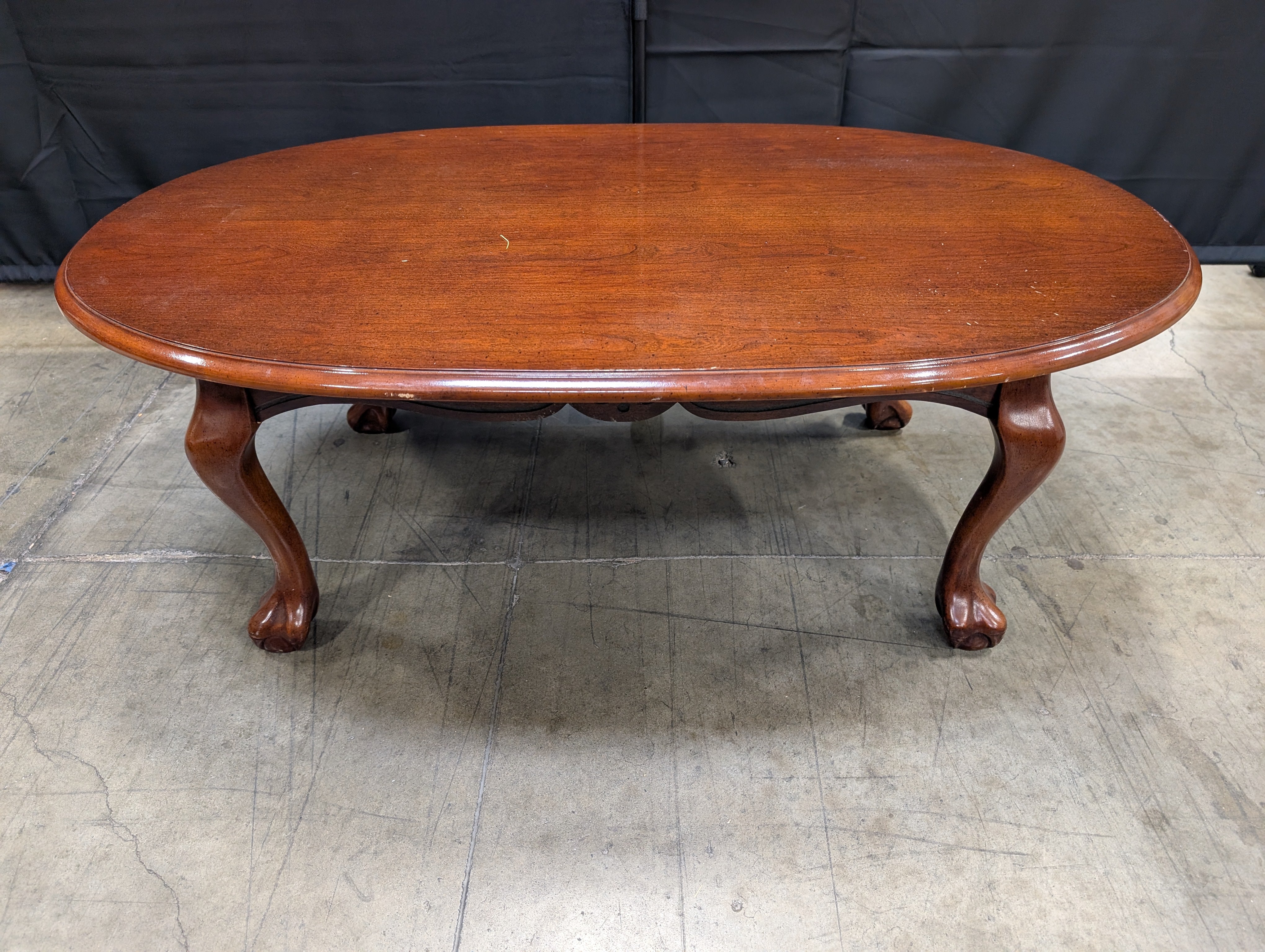 Rich Cherry Wood Oval Coffee Table with Curved Legs