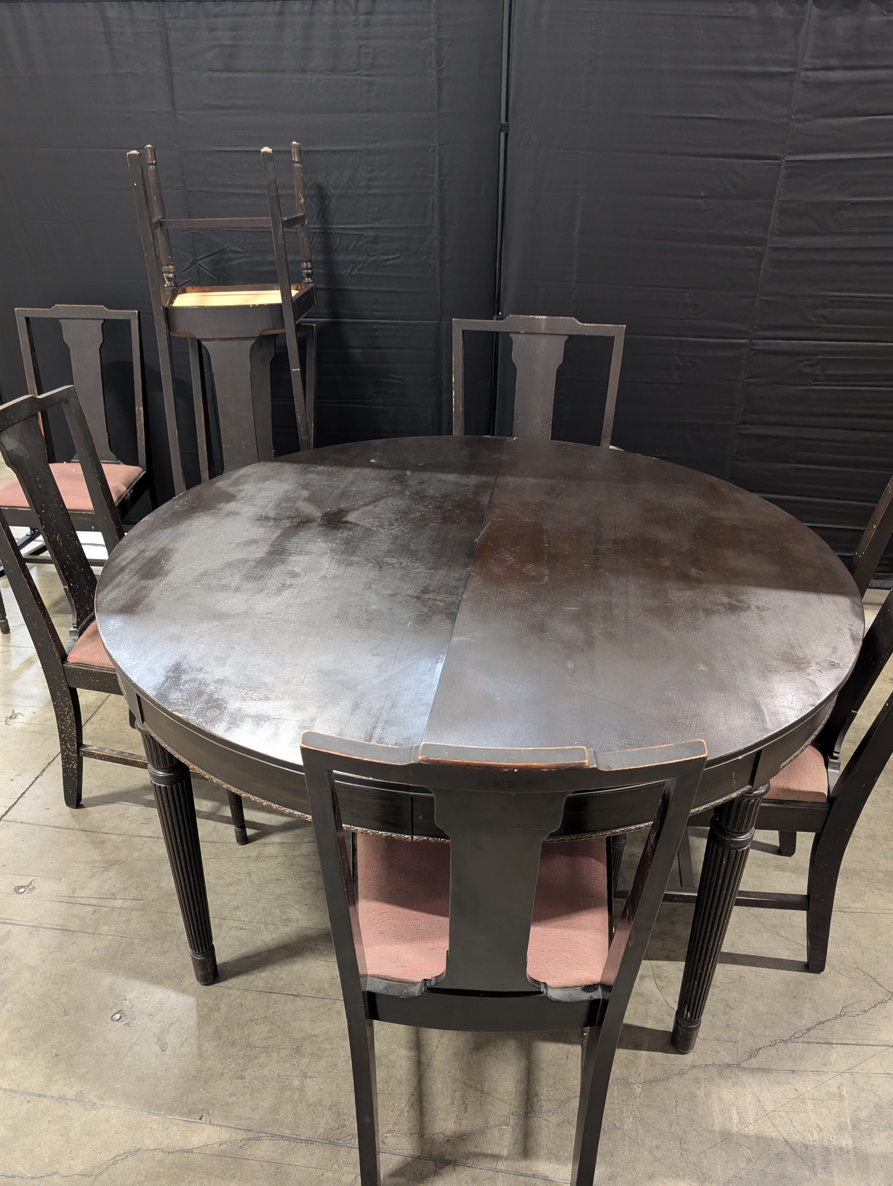 Dark Wood Oval Extendable Dining Table with Seven matching Chairs