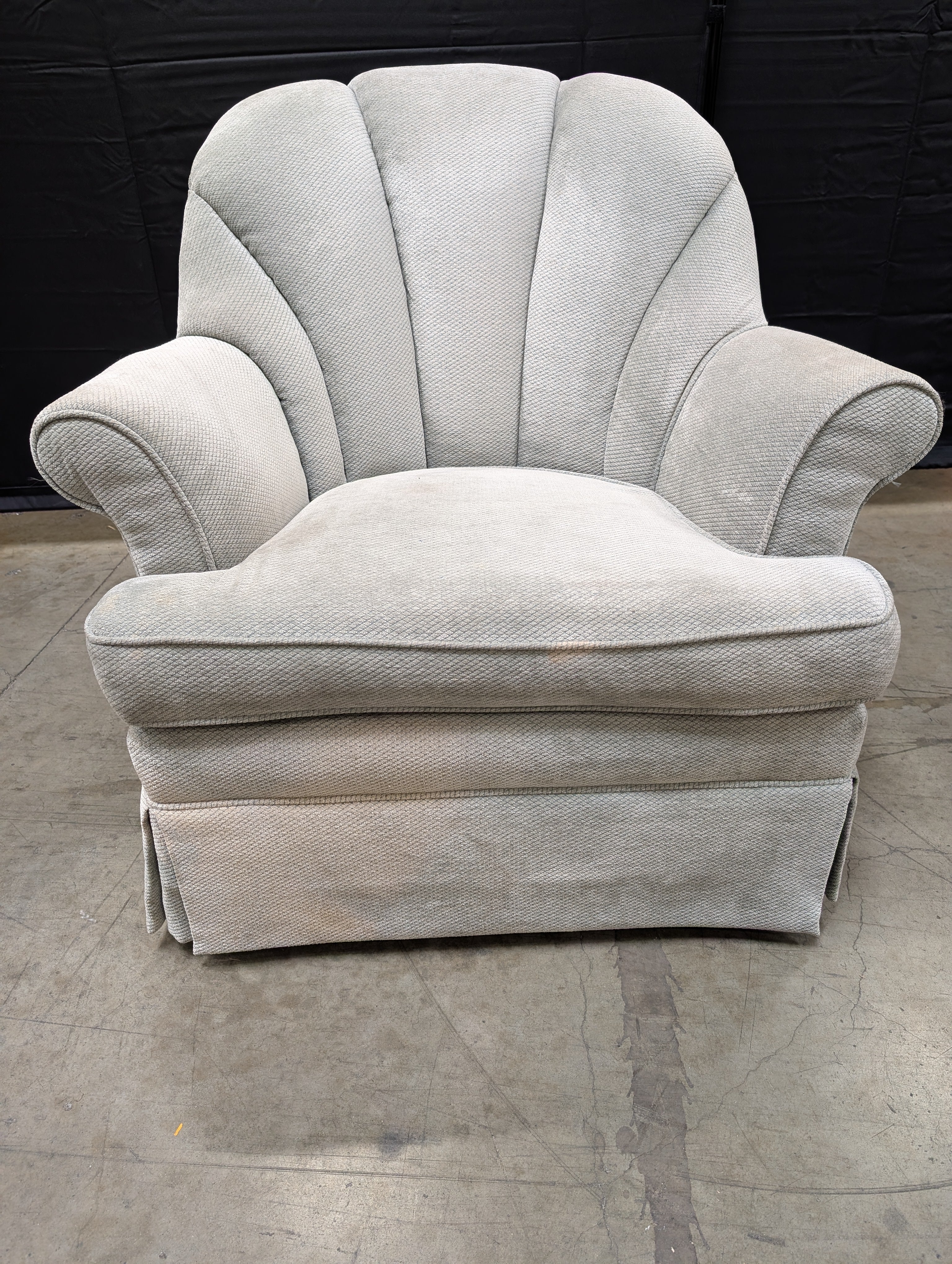 Textured Upholstered Scalloped Back Swivel Armchair